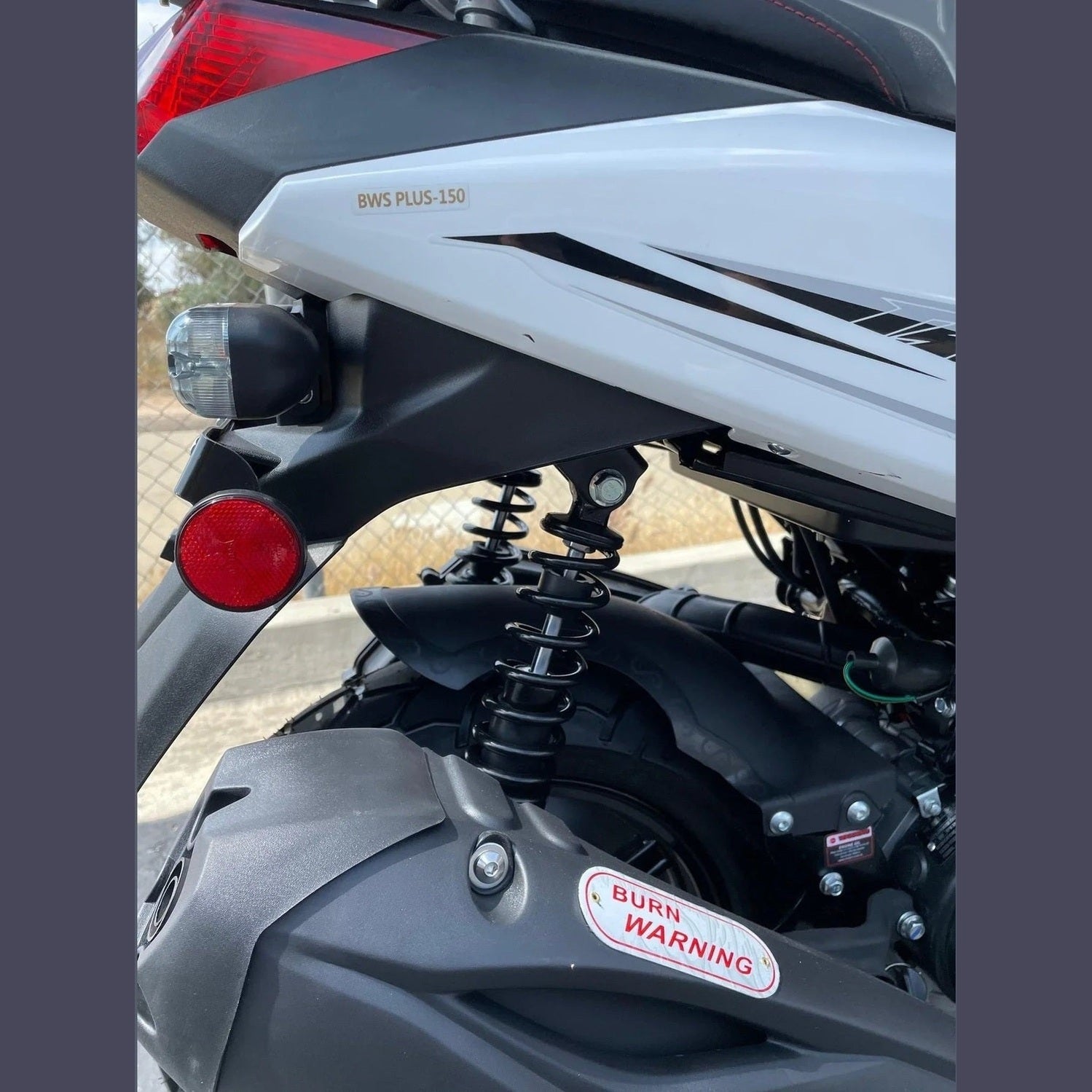 Rear suspension and taillight detail on white Ranger 150cc scooter