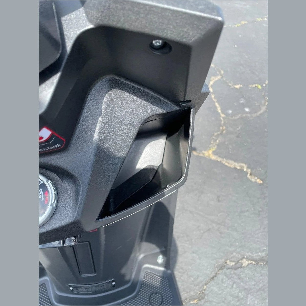 Black textured footwell storage compartment and ignition key slot