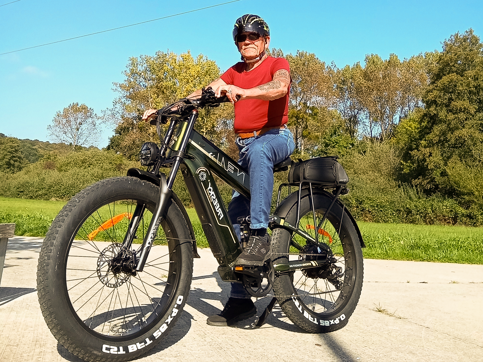 Man riding olive green Freesky Alaska e-bike on path