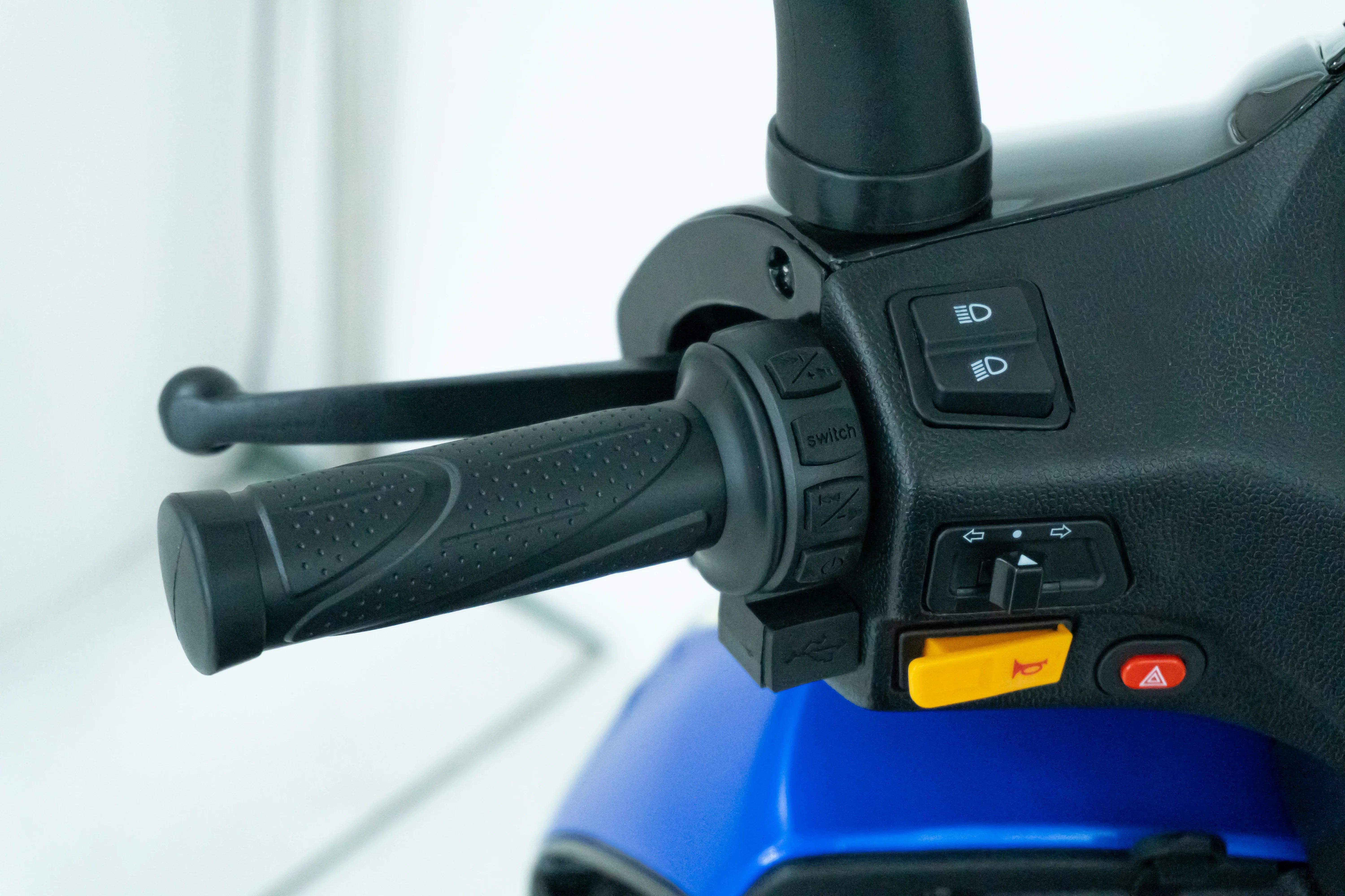 Blue powersport vehicle handlebar with control buttons and textured grip