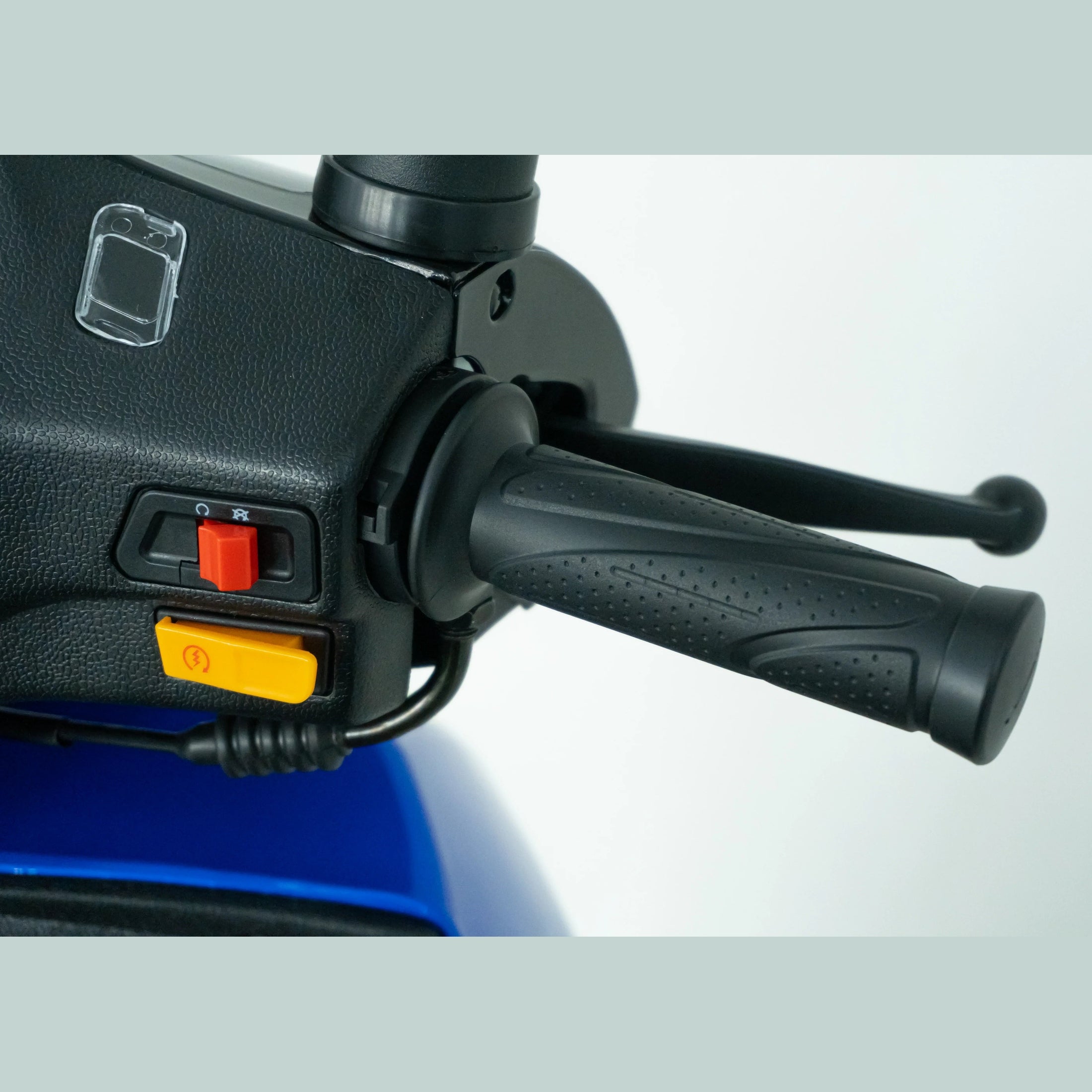 Close-up of scooter or motorcycle handlebar with control switches and textured grip