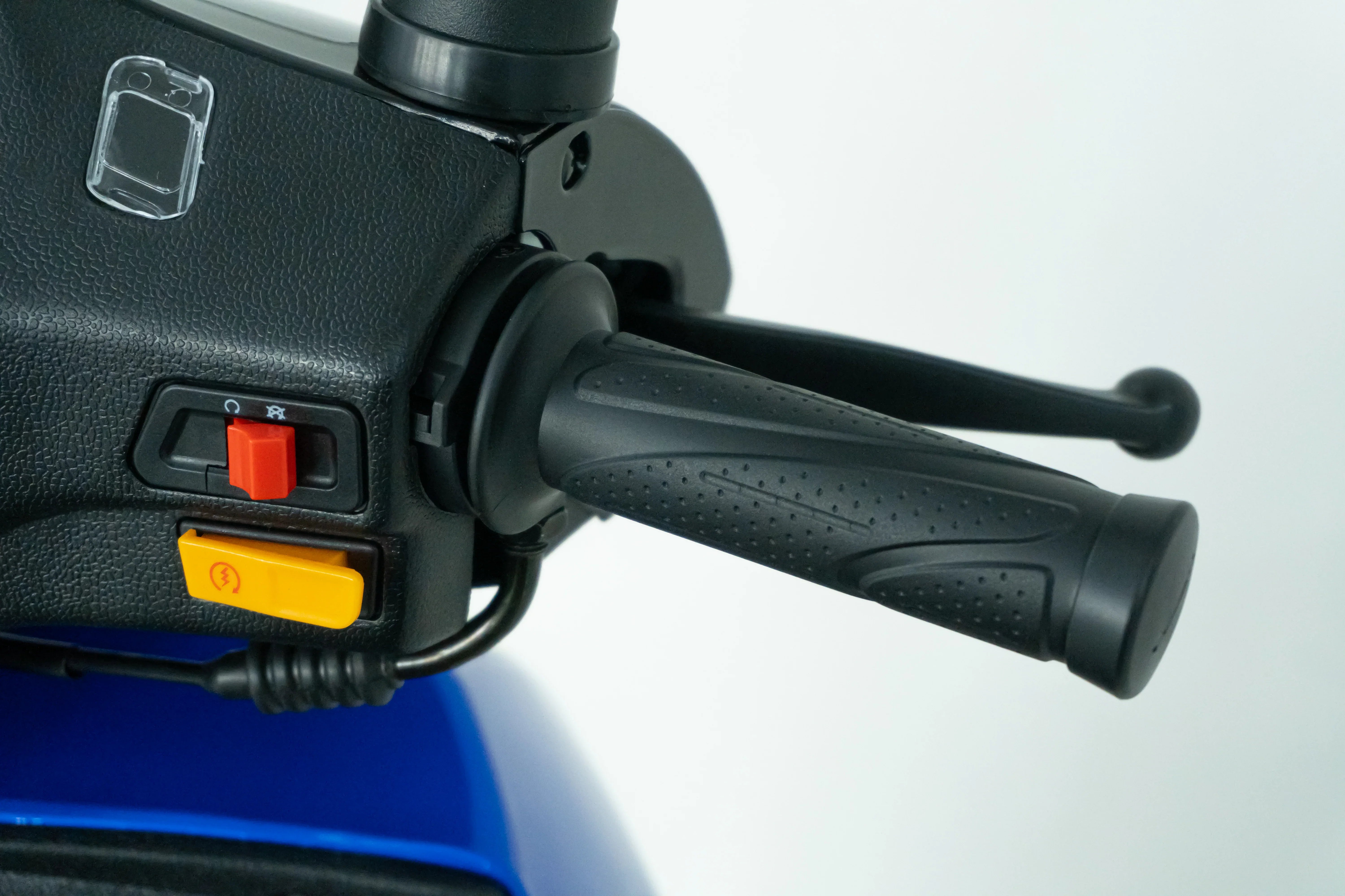 Close-up of scooter handlebar with red and yellow control switches for power and lighting