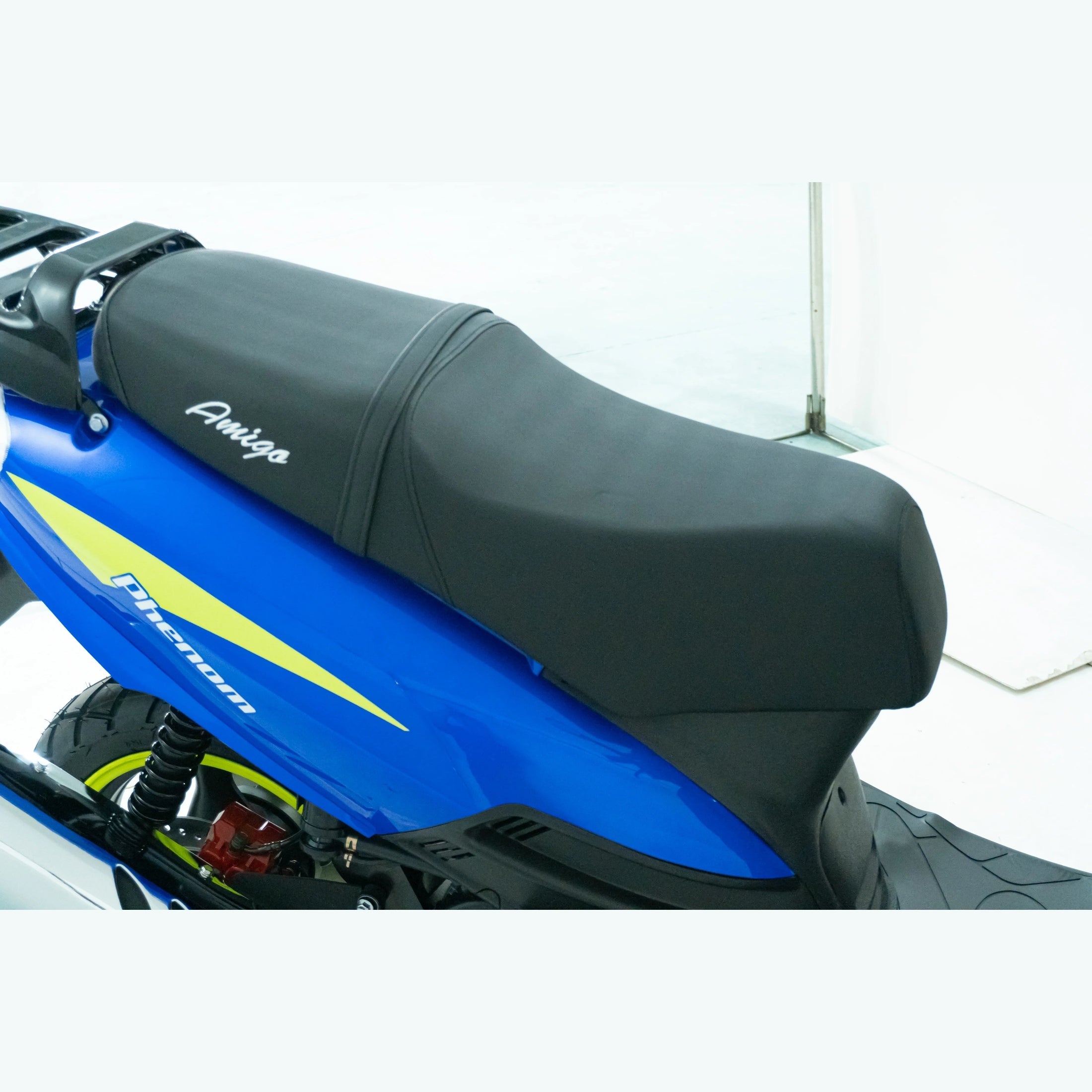 Close-up of black Amigo scooter seat with blue and yellow Phenom body panel