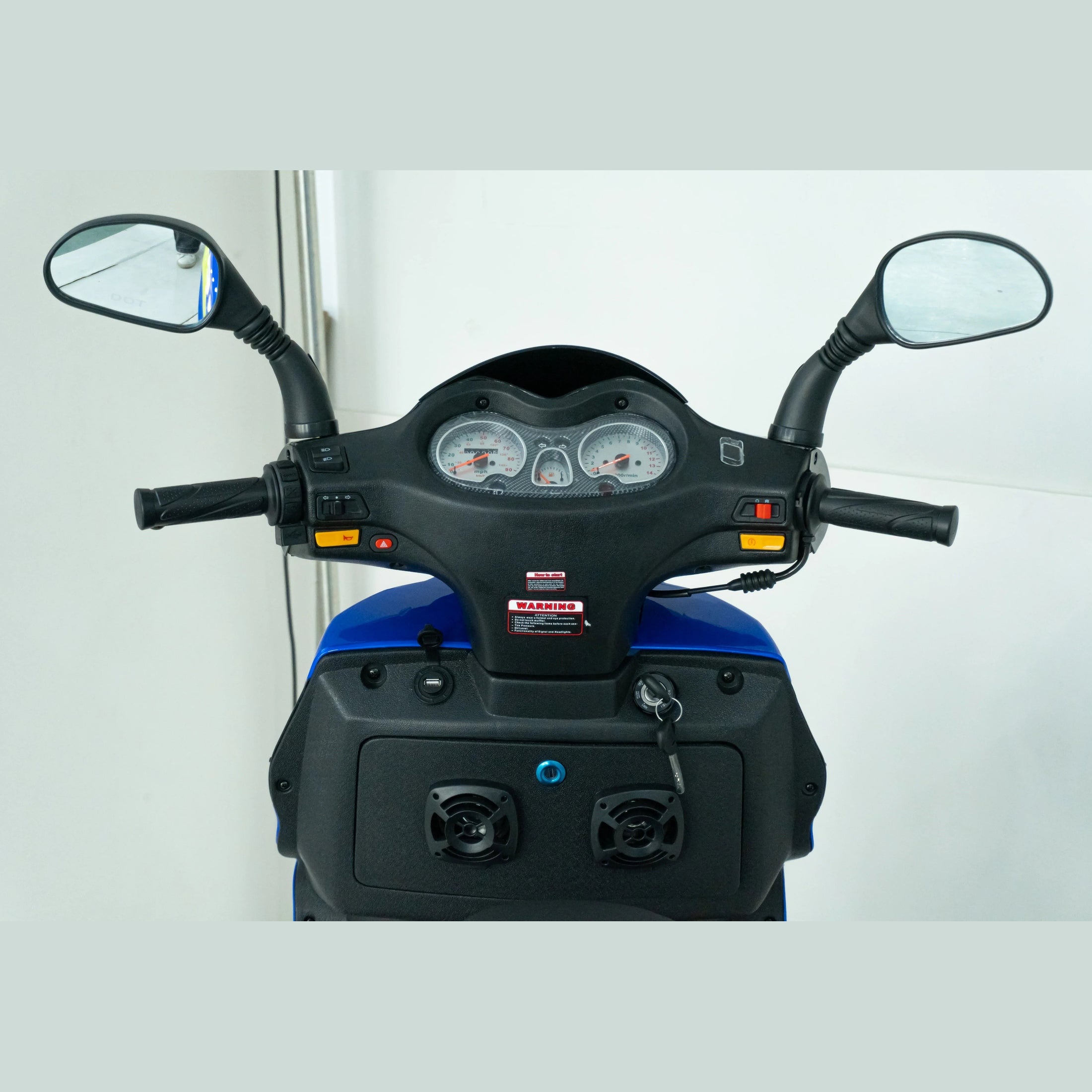 Close-up of blue scooter dashboard, handlebar controls, rearview mirrors, and gauges.