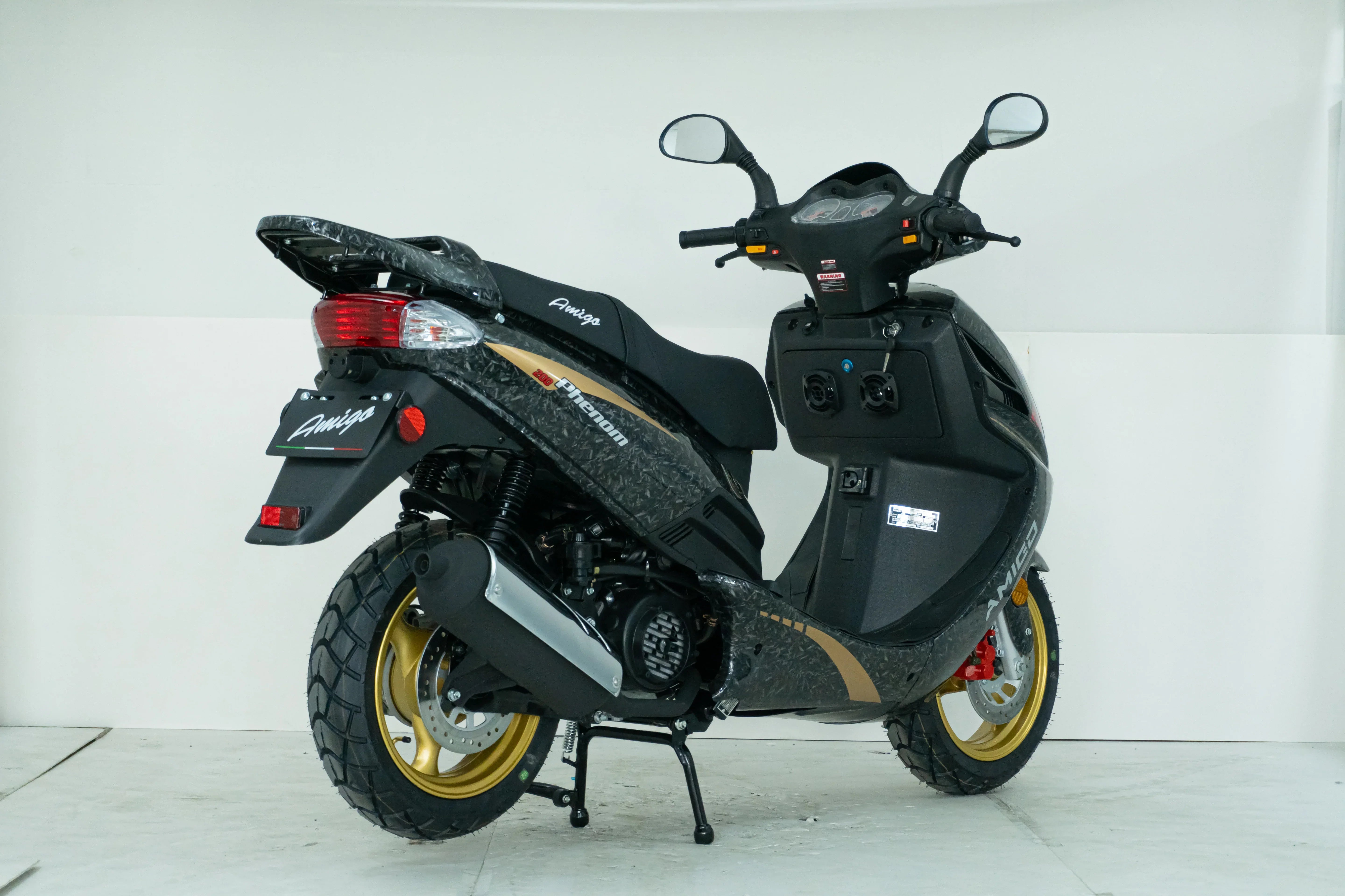 Amigo Phenom 200cc scooter with gold rims and black carbon fiber design, ideal for urban commuting.
