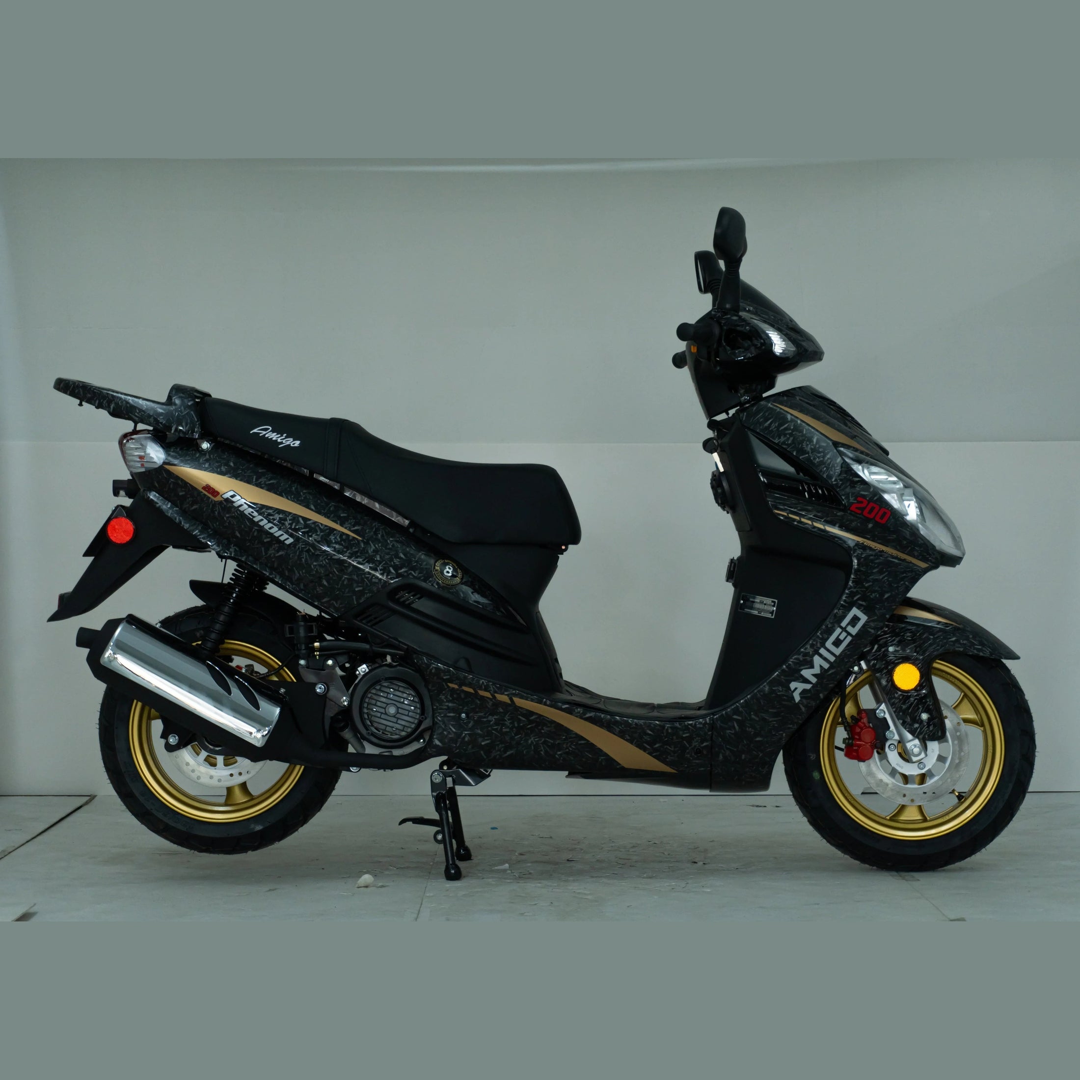 Black and gold motor scooter with AMIGO branding, side view, on gold alloy wheels