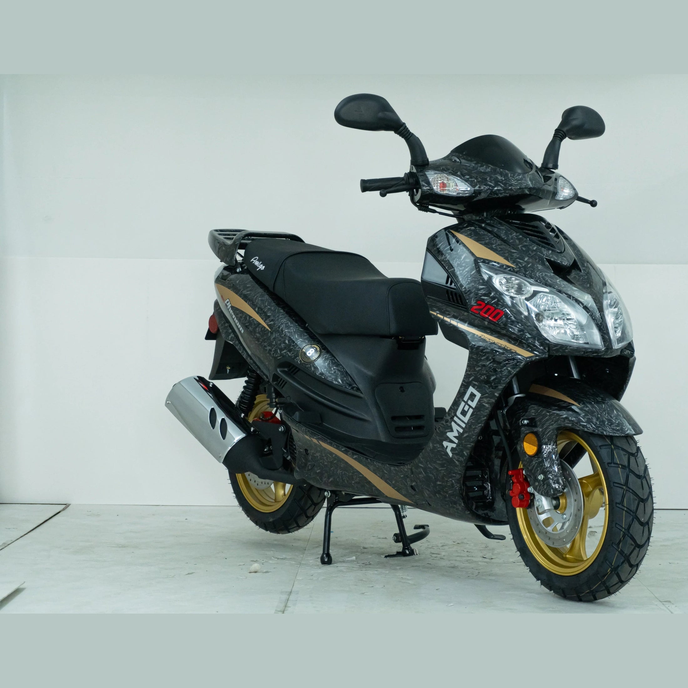 Black and gold Amigo 200cc scooter with dual headlights and sporty tires in a studio setting