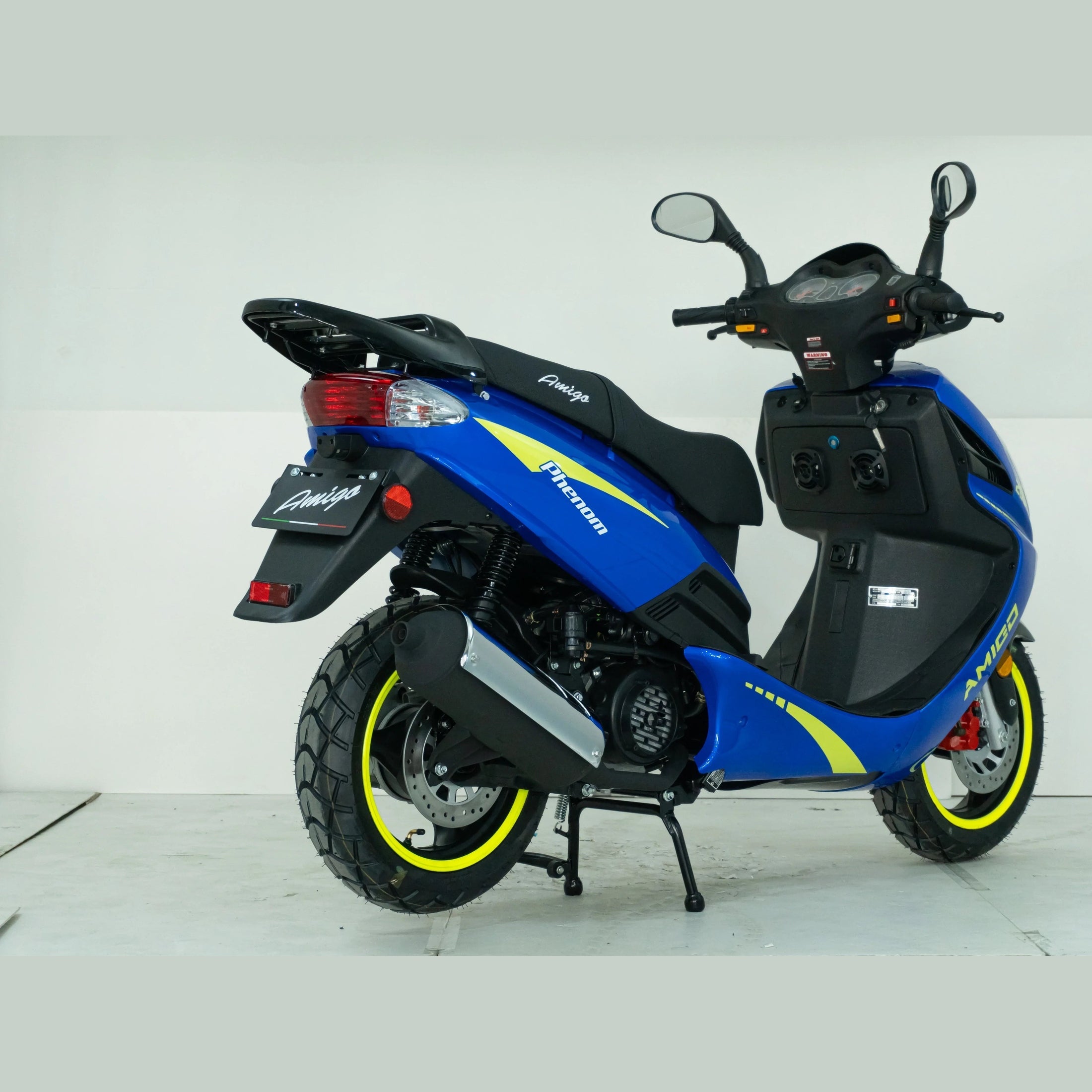 Blue Amigo Phenom scooter with yellow accents, rear angle, in studio setting