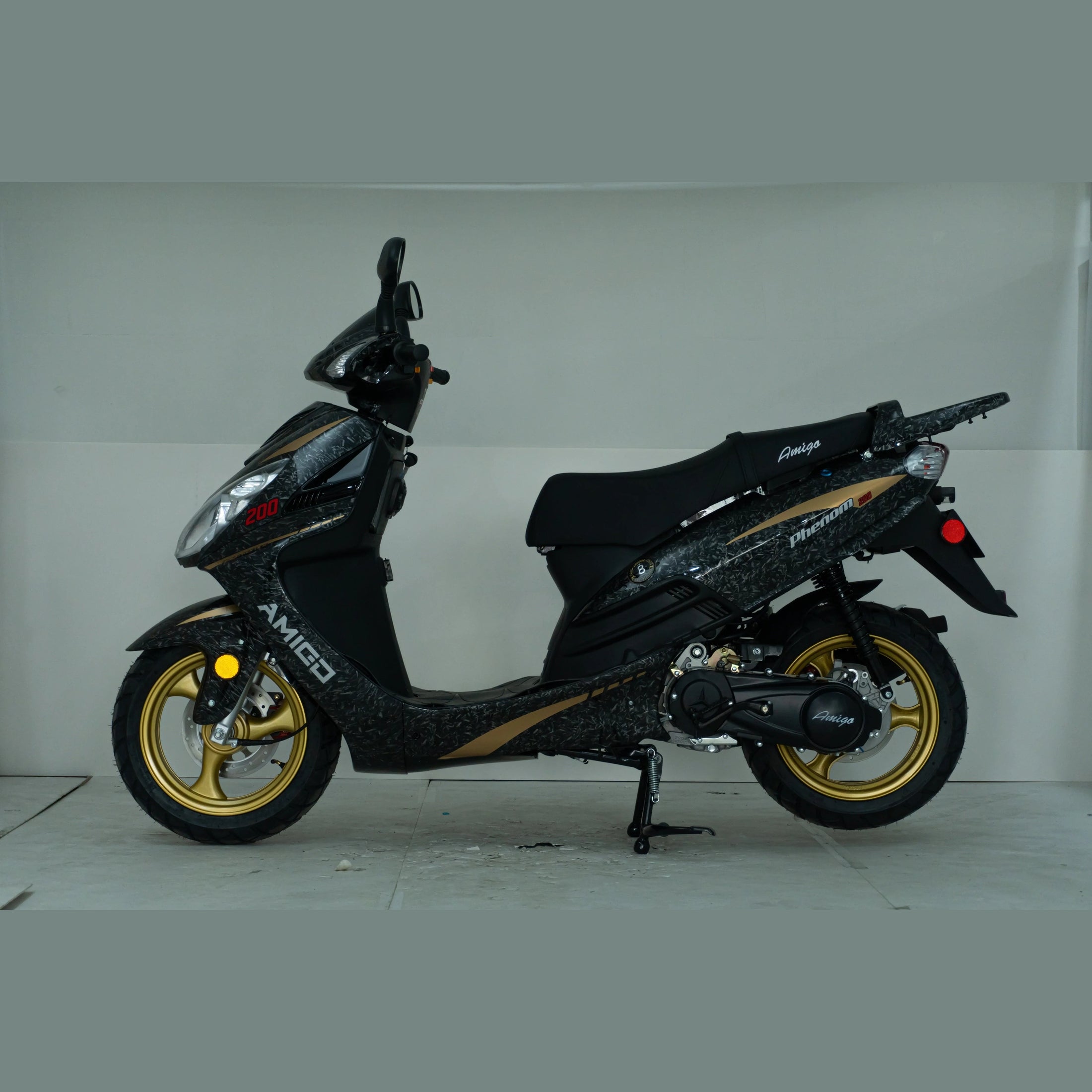 Black Amigo Phenom 200cc scooter with gold wheels in indoor studio setting