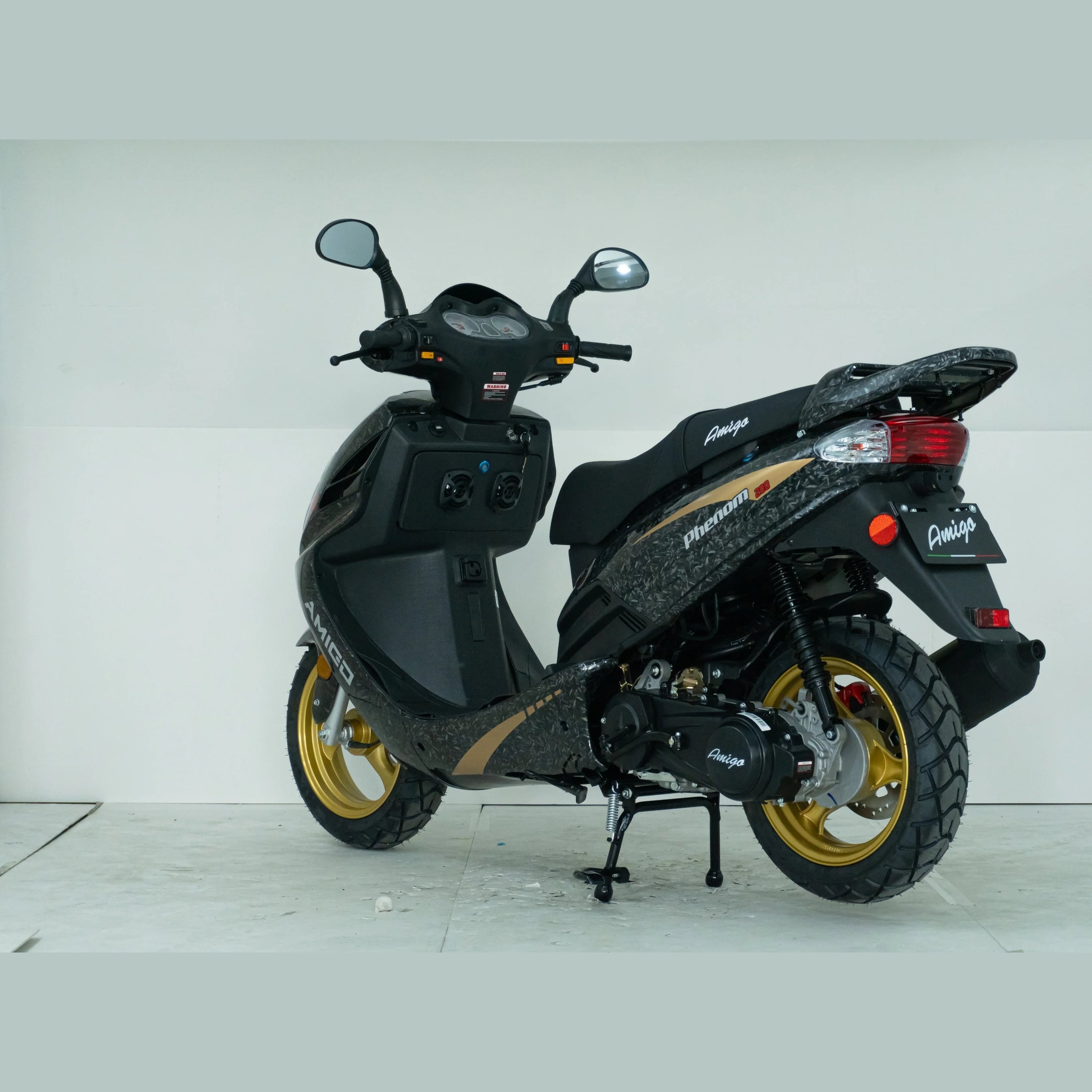 Black and gold Amigo Phenom 150cc scooter with gold wheels in a studio setting
