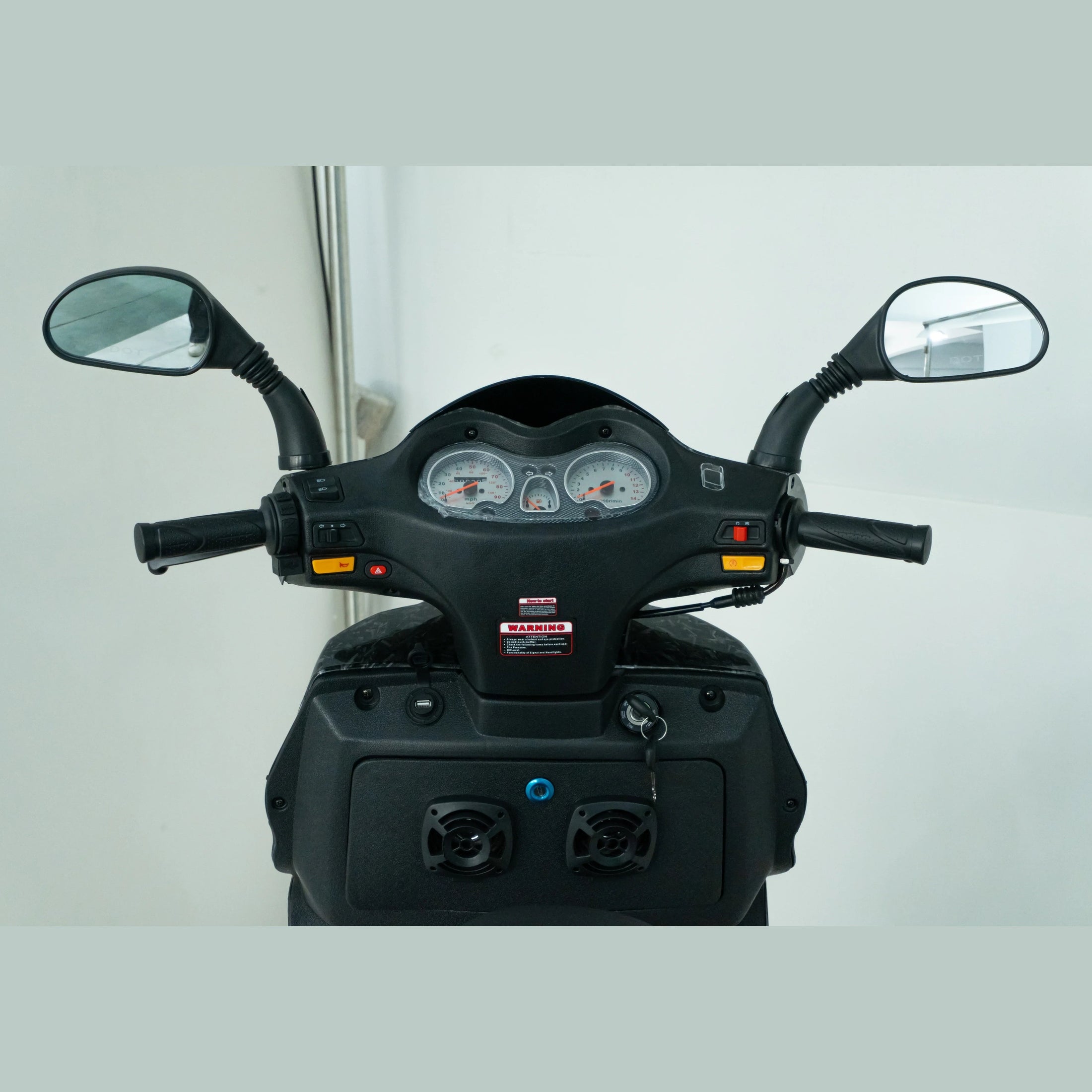 Close-up of scooter handlebars with dashboard, speedometer, and rearview mirrors