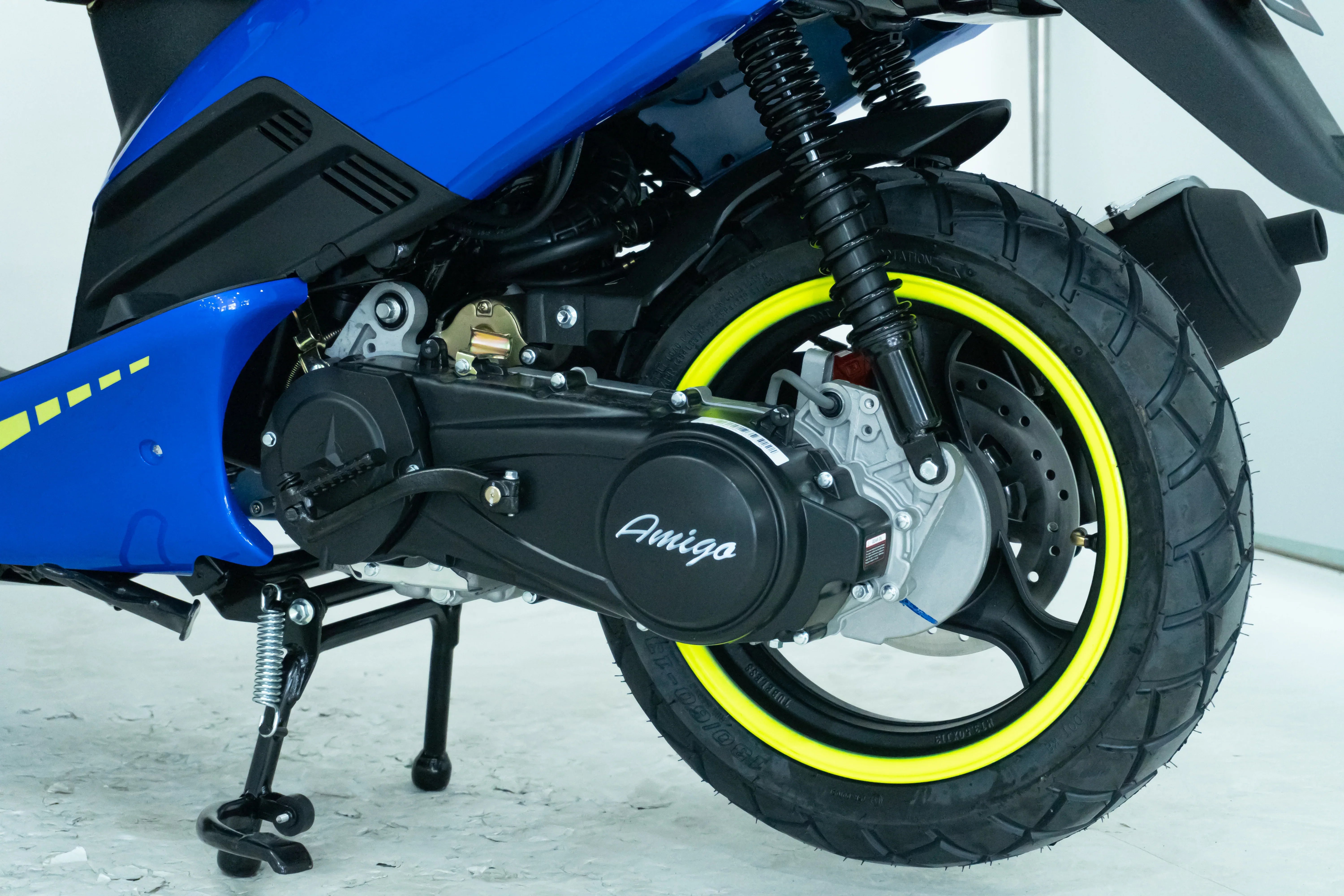 Blue Amigo scooter with yellow-rimmed tire and visible engine details