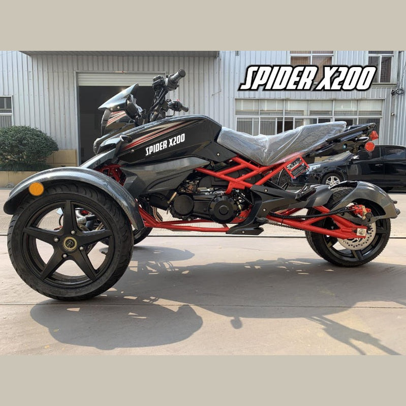 Black Spider X200 trike parked outdoors with plastic seat cover and concrete background
