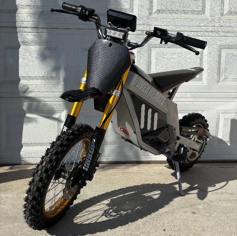  hoverhearts dirt bike in front of a white garage door.