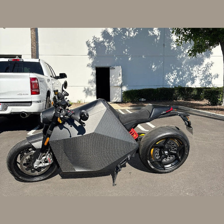 DAVINCI DC100 electric bike side view with red suspension springs and yellow rear rim