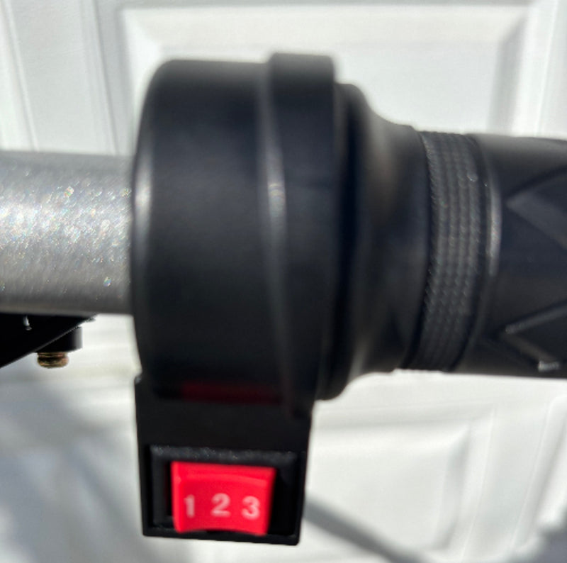 Close-up of a hoverhearts dirt bike handlebar with a red 3 speed switch on it