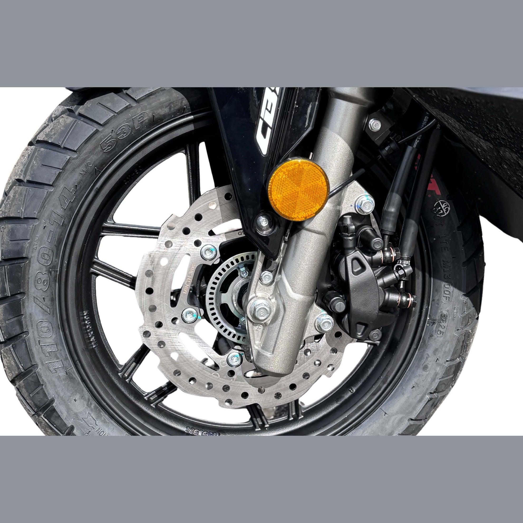 Close-up of Amigo 200 front wheel with spoked rim, disc brake, and knobby tire
