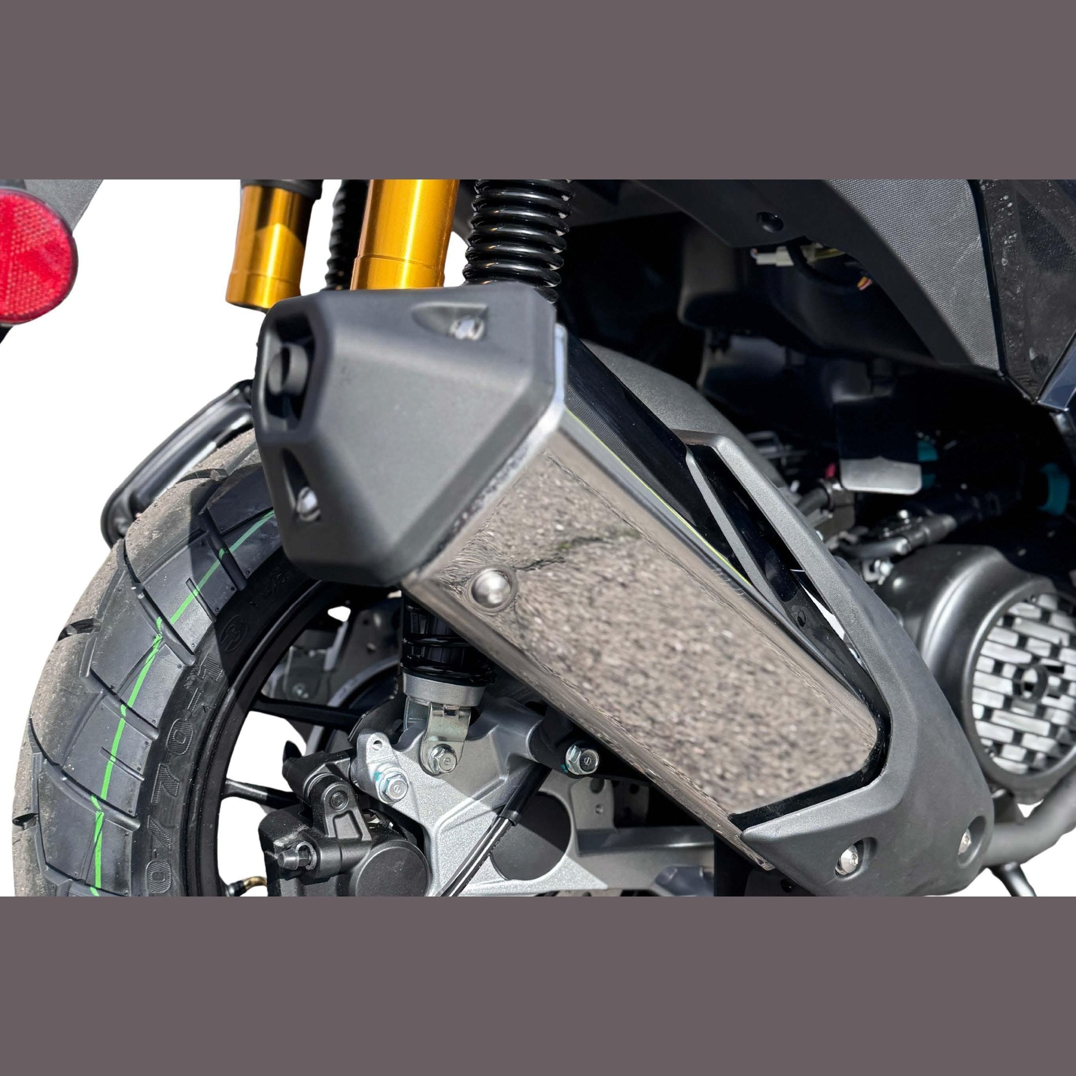 Close-up of Amigo 200 exhaust heat shield and rear wheel with green stripe tire