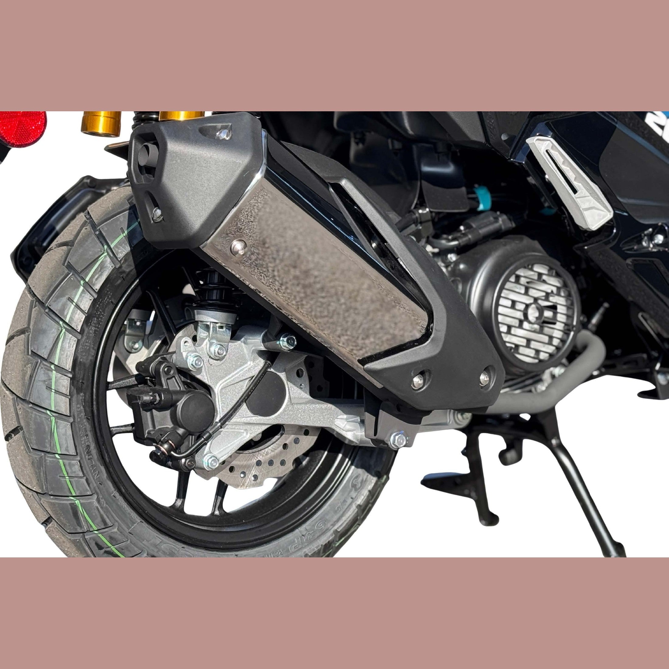 Close-up of Amigo 200 rear swingarm, disc brake assembly, and knobby tire