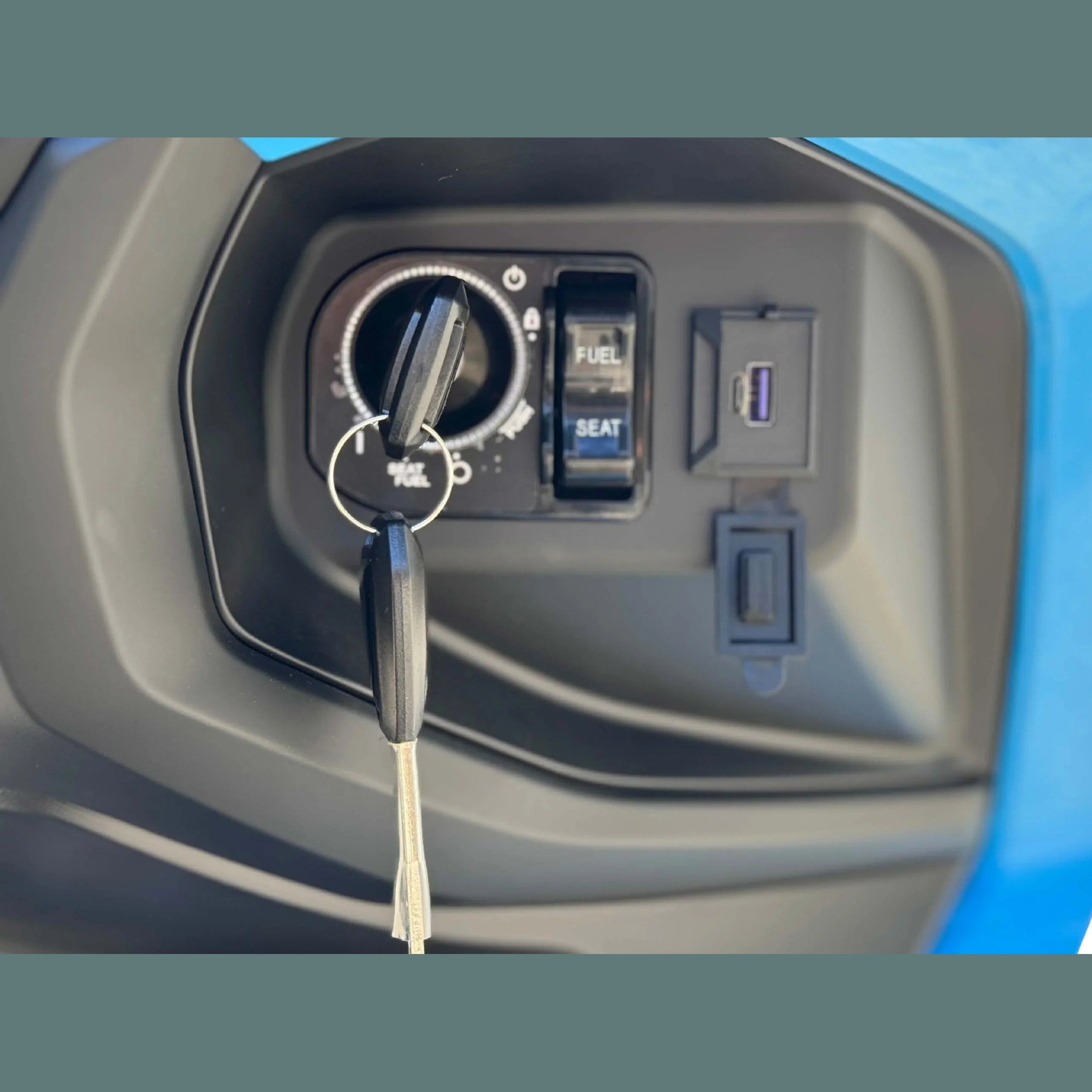 Close-up of Amigo 200 ignition switch with USB port and fuel controls
