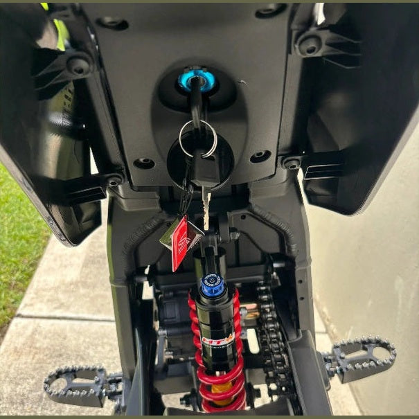 rear view of black Atlis Sigma e-bike showing red coil shock and illuminated ignition