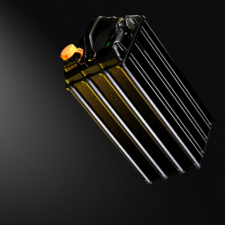 Surron black battery pack with ribbed cooling fins and orange protective cap