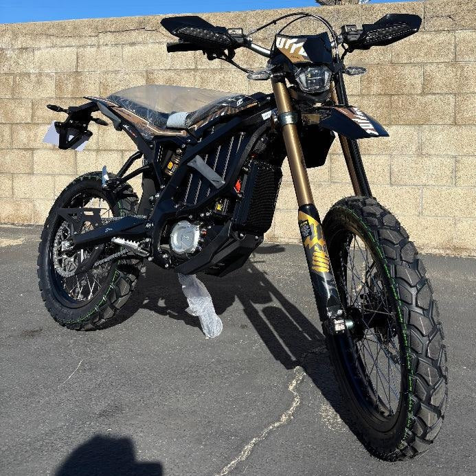 Front angle of black Surron Ultra Bee R electric dirt bike with disc brakes