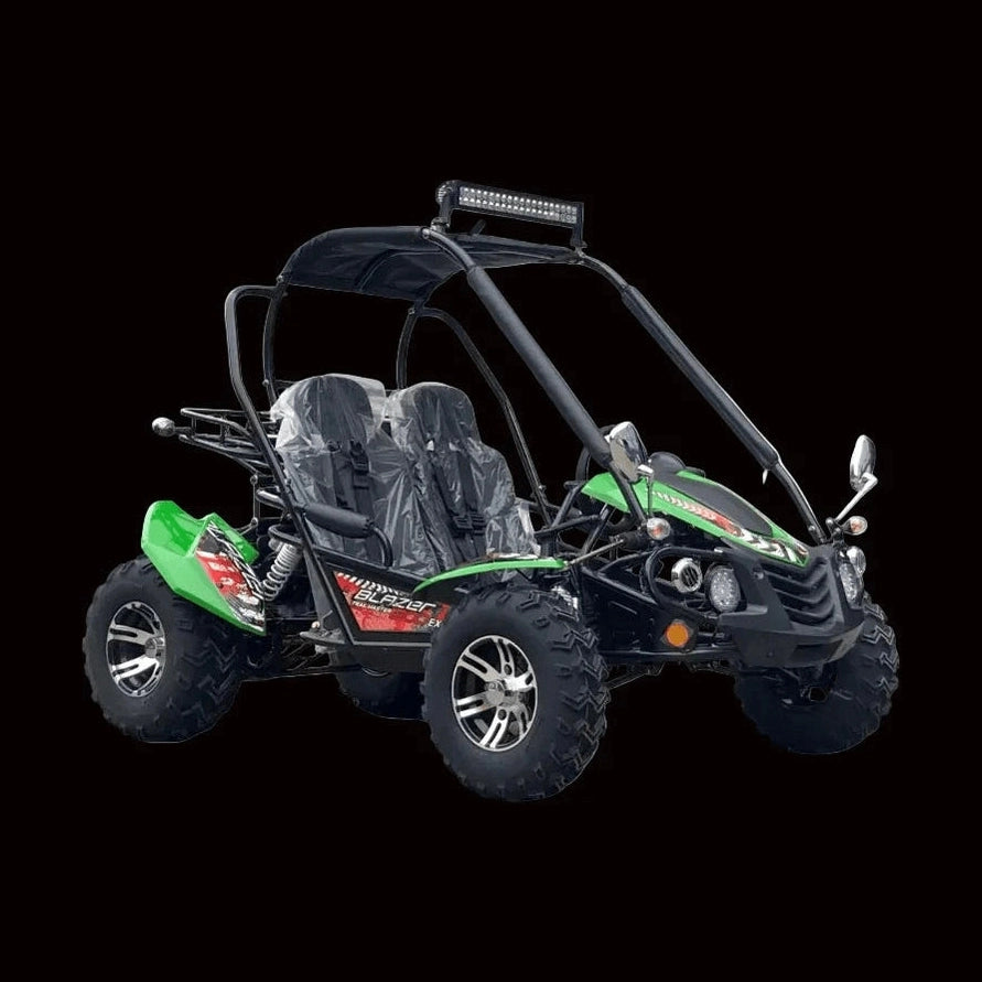 Green TrailMaster Blazer 200EX go-kart side view with roll cage and knobby tires