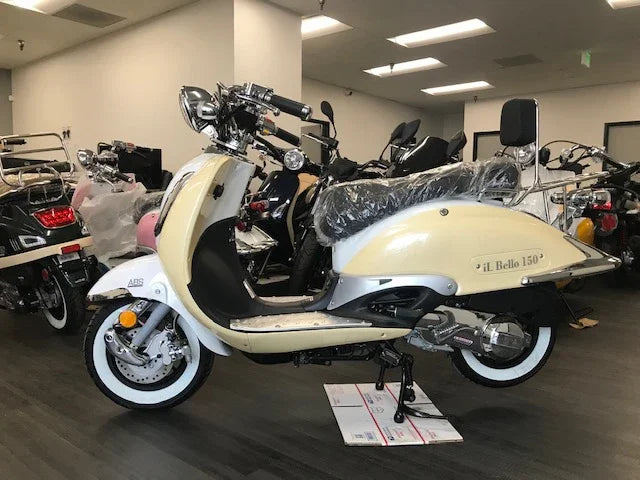 Cream and white JL Bello 150cc scooter on showroom floor with whitewall tires