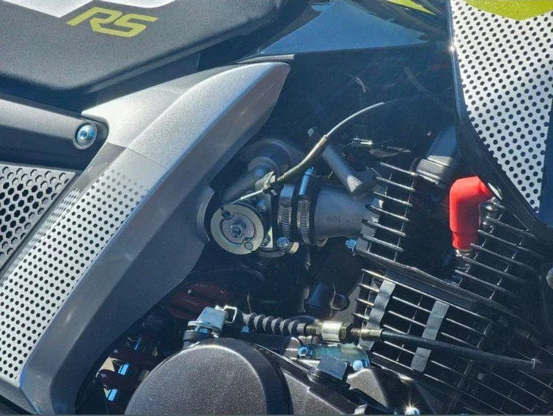 Close-up of Lifan KP Mini 150cc engine area with silver carburetor and perforated shroud