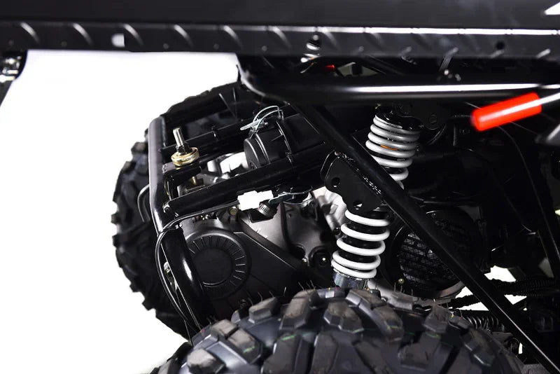 Close-up of ATV rear suspension and coil spring with off-road tires