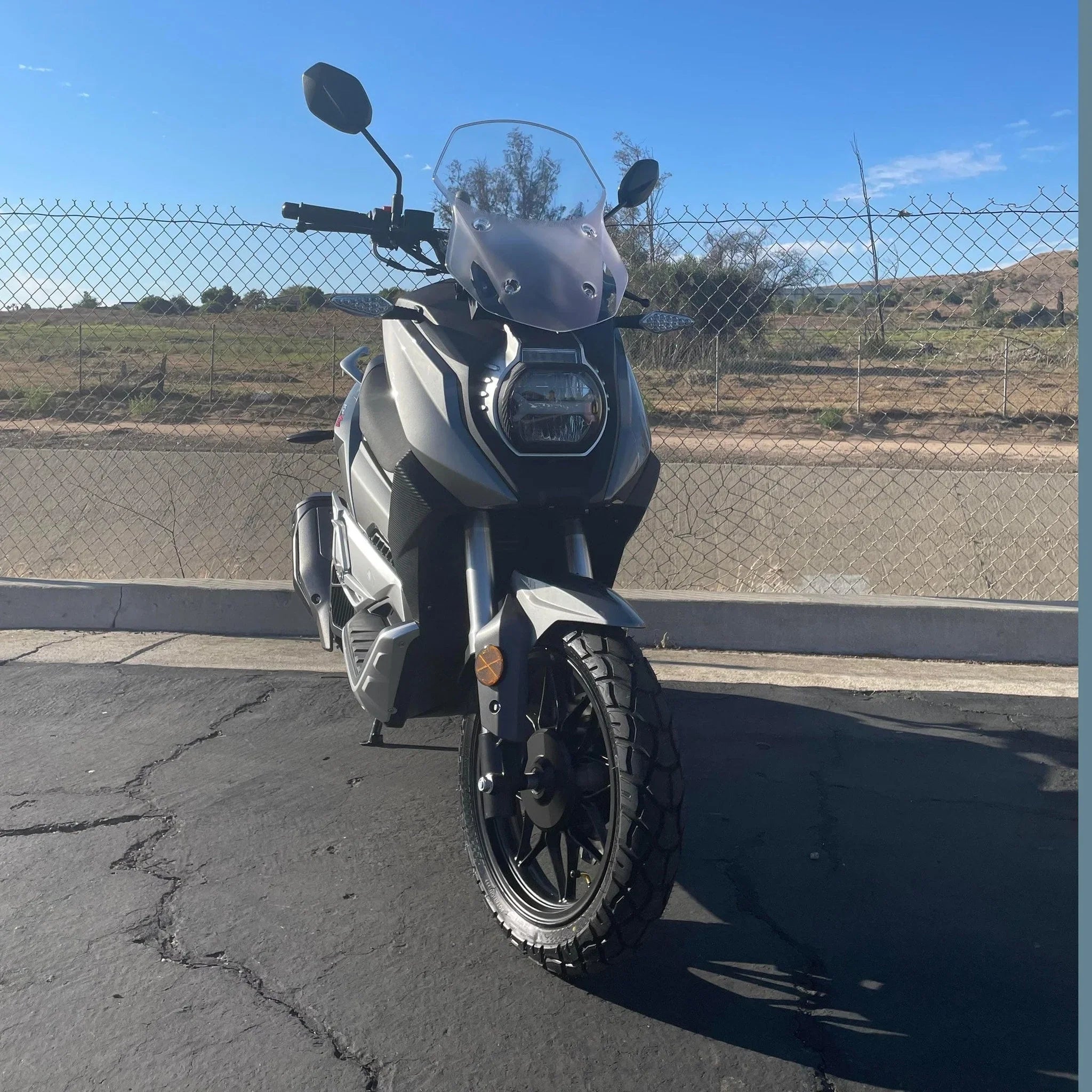 Front view of silver Lifan KPV 150 ADV with round headlight and windscreen