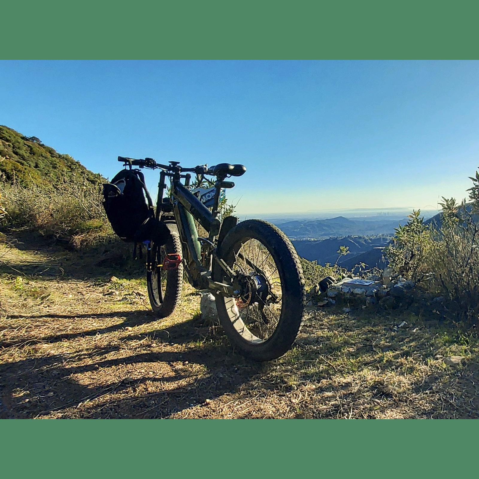 Green Freesky e-bike with rear rack on dirt trail