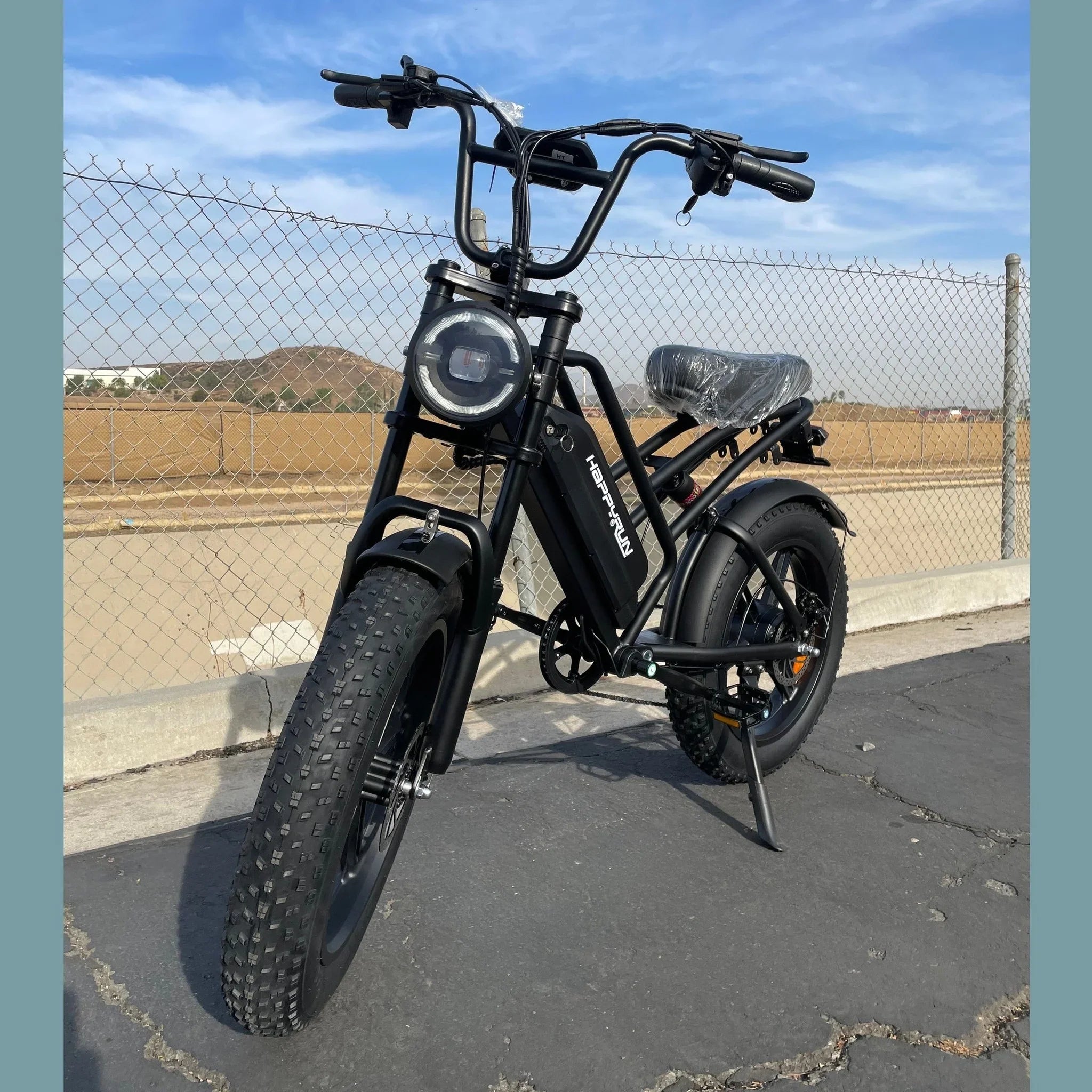 Front view of black Happy Run G50 e-bike with LED headlight