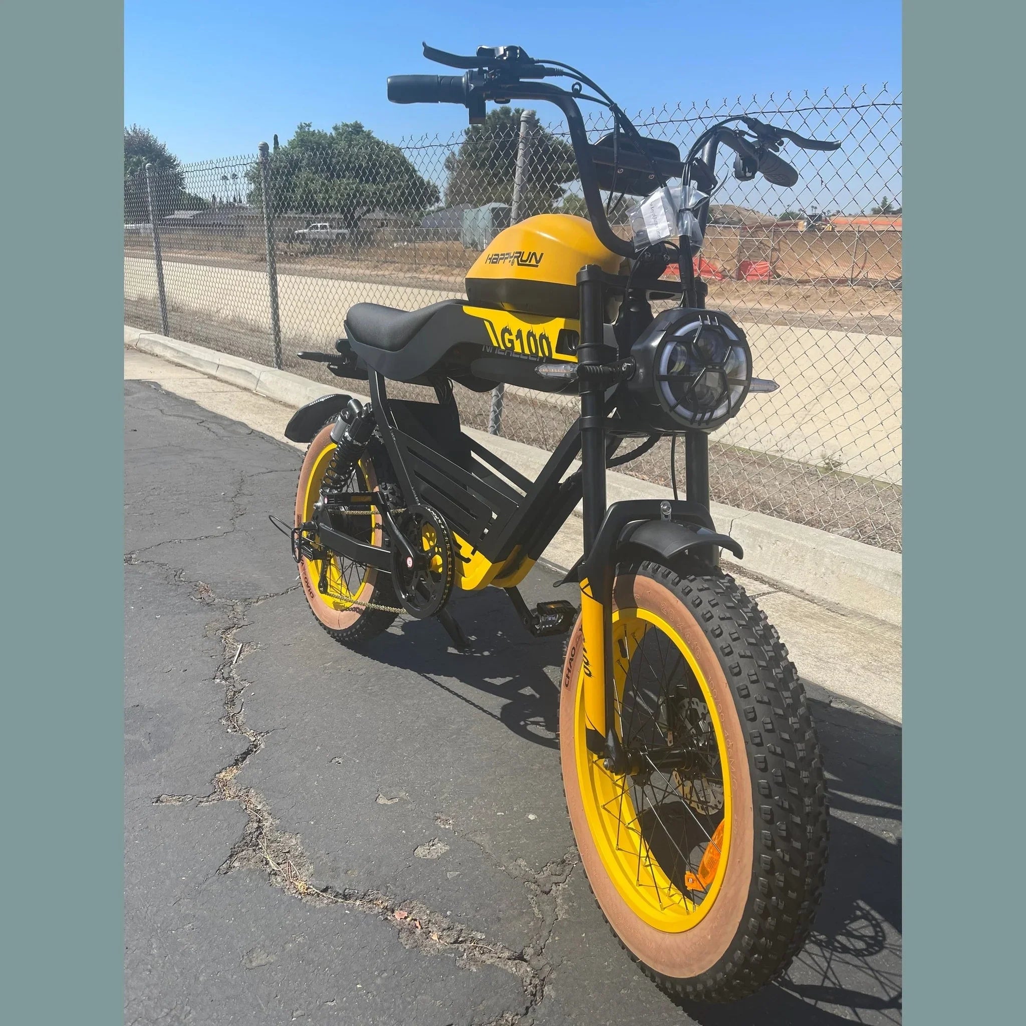 Yellow Happyrun Tank G100 electric bike angled front view outdoors