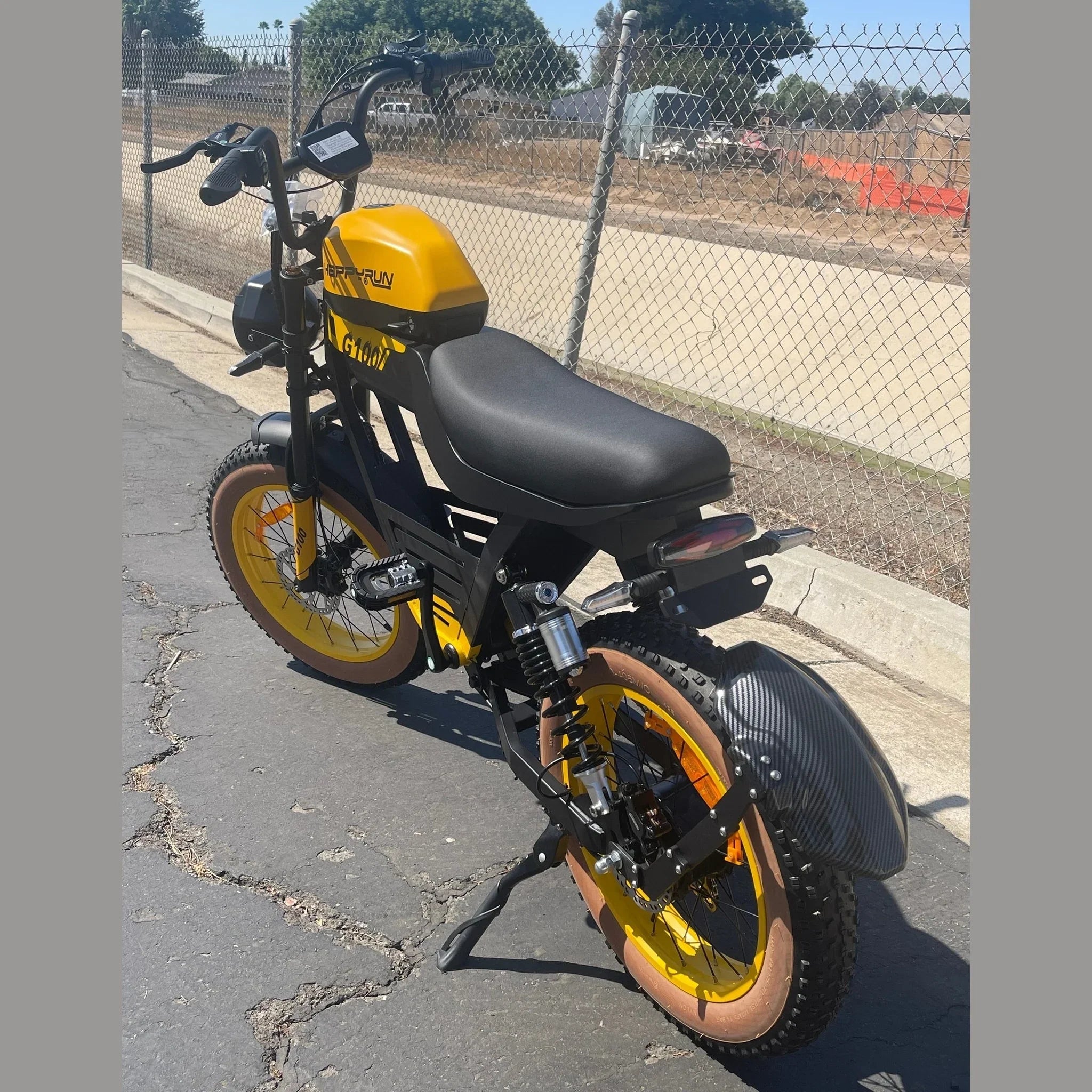 Rear three-quarter view of yellow and black Happyrun Tank G100 e-bike