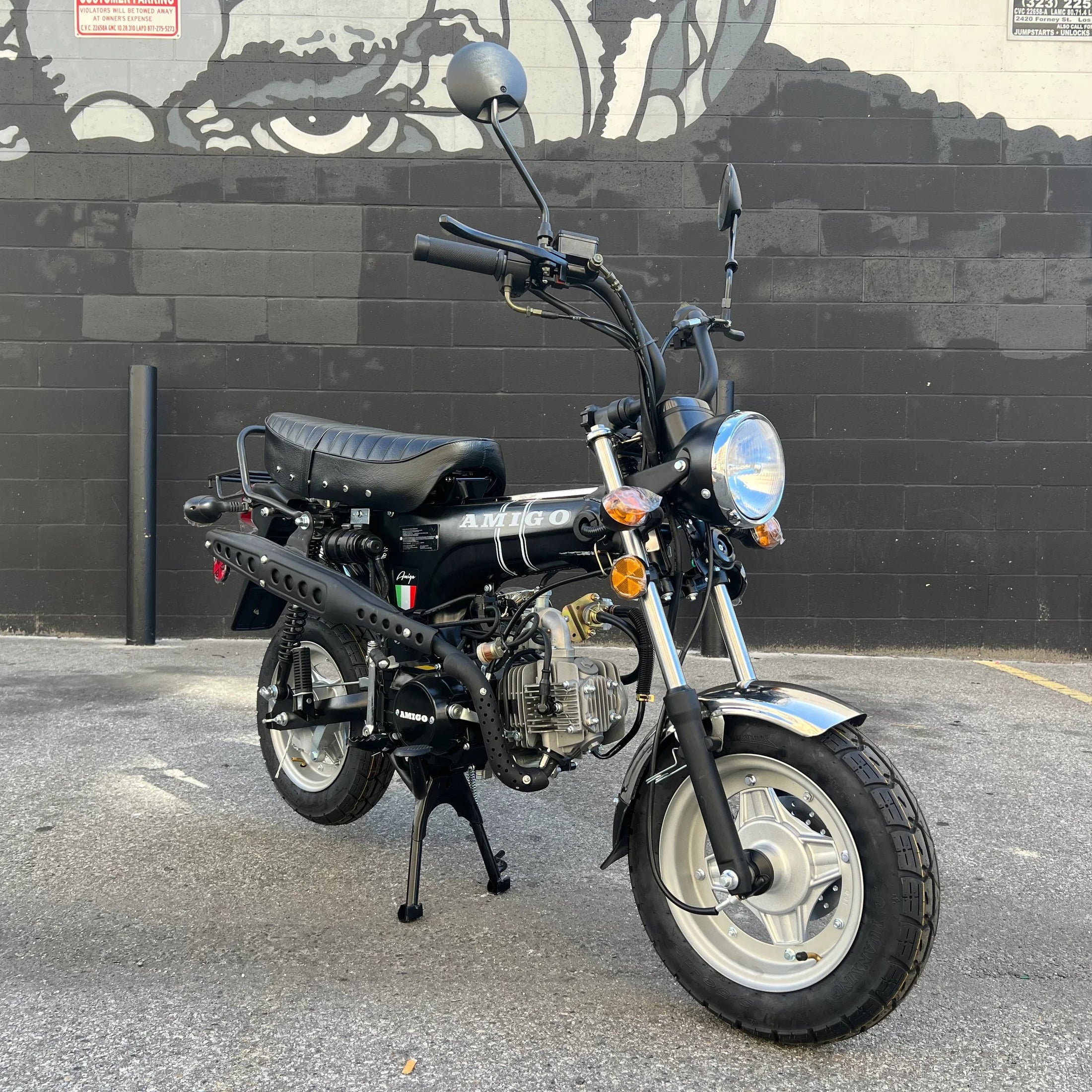 Black Amigo Rocky 125cc mini motorcycle on asphalt with center stand deployed