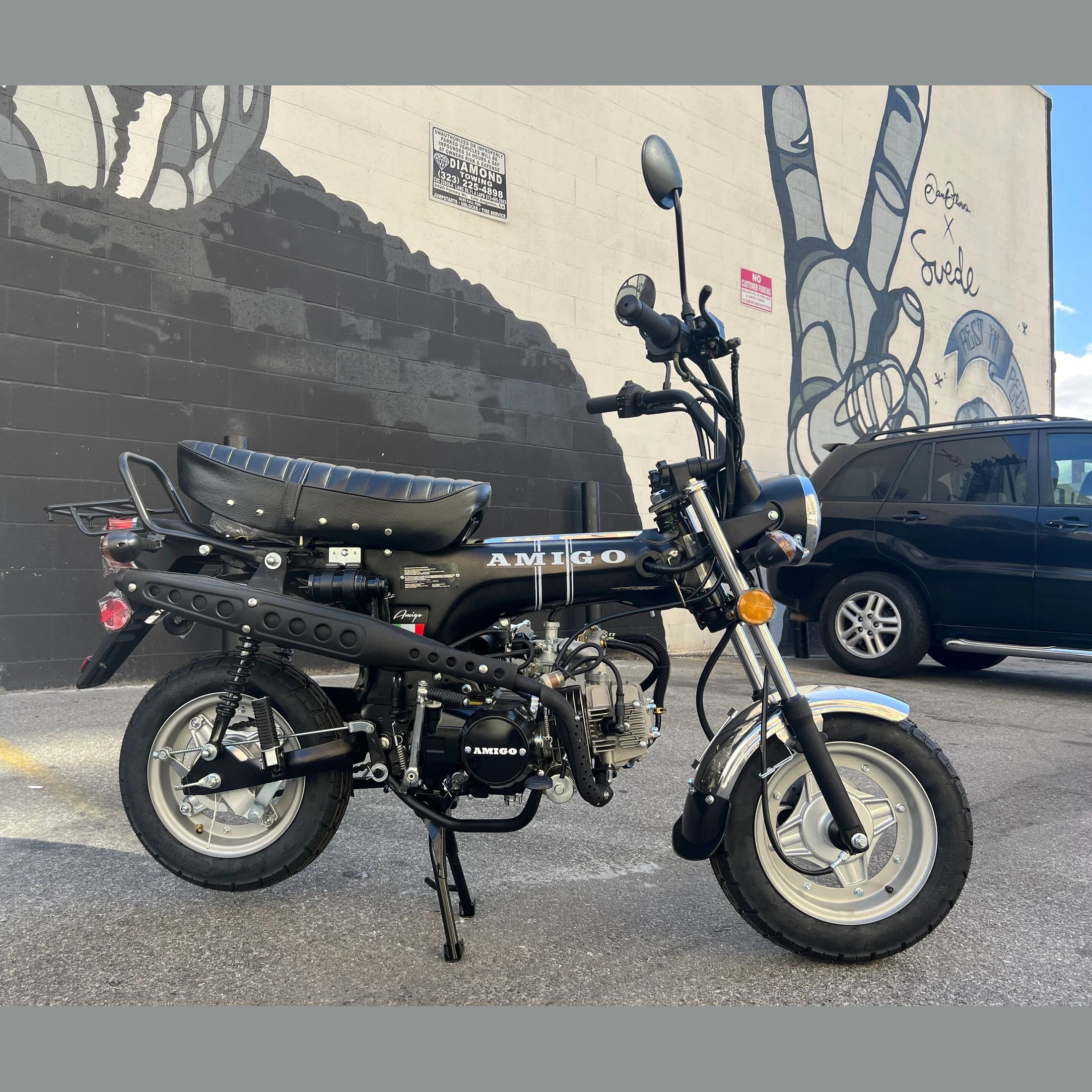 Black Amigo Rocky 125cc mini motorcycle side profile with white stripes and Italian flag decal