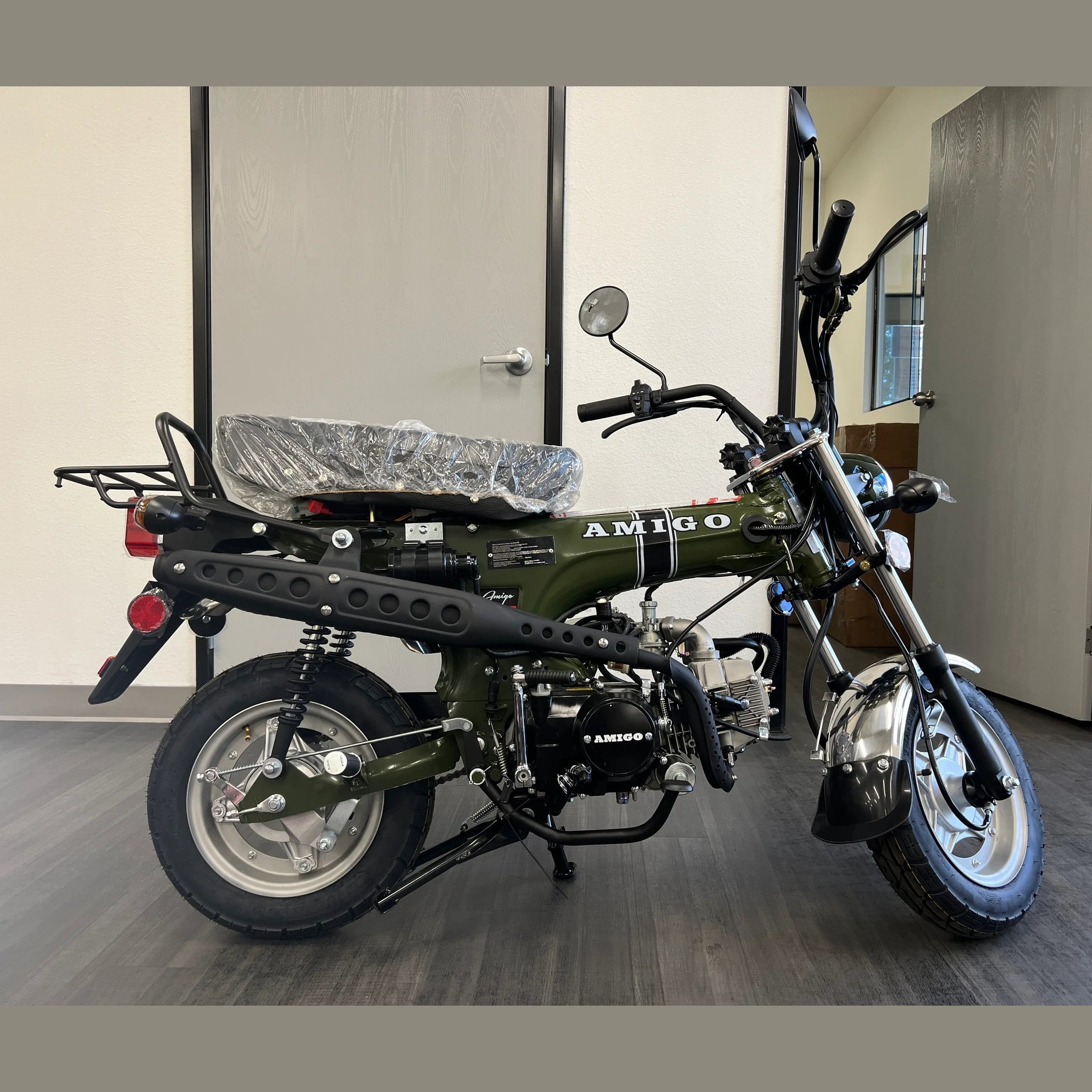 Olive green Amigo 125cc mini bike side view with rear suspension and luggage rack