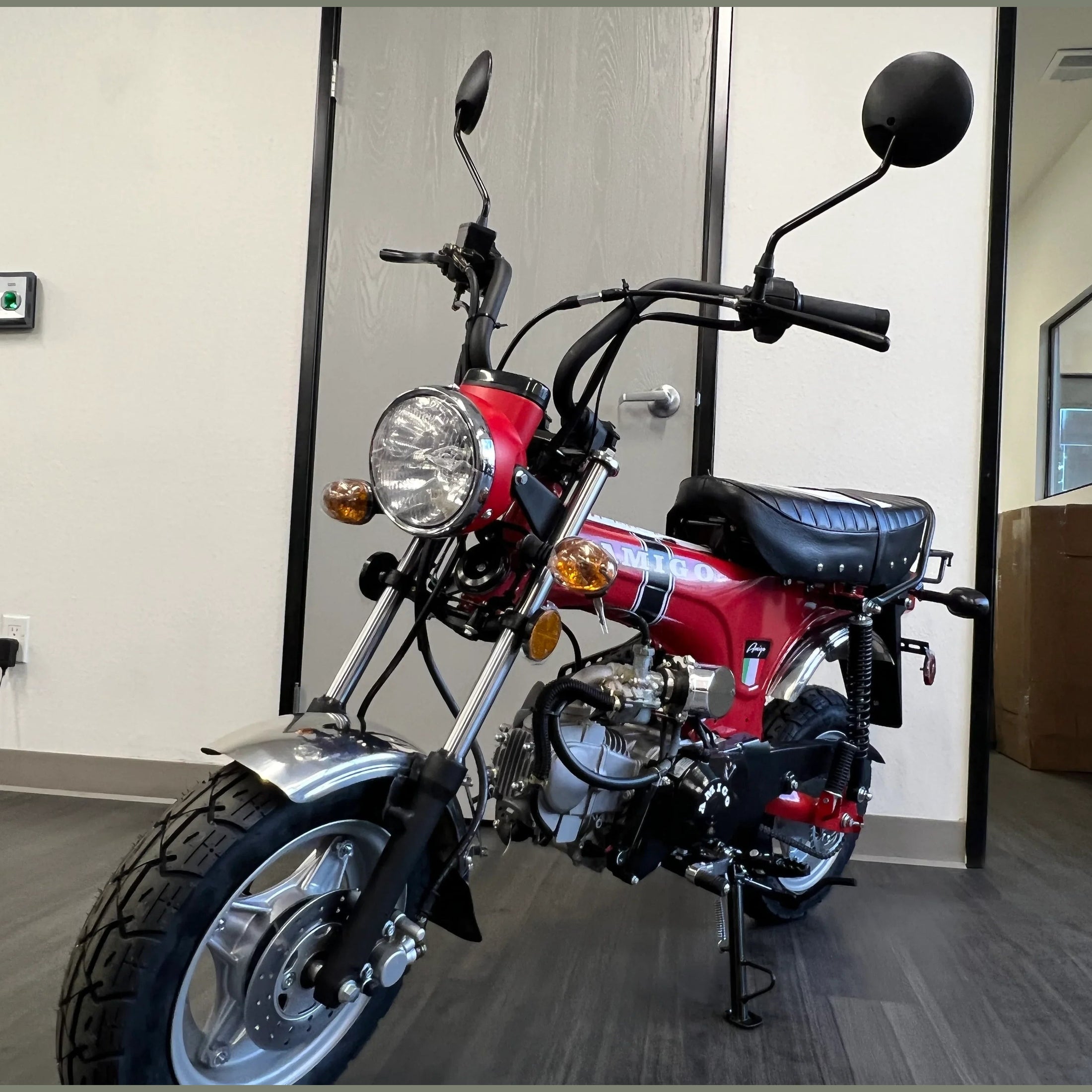 Red Amigo Rocky mini bike front three-quarter view with round headlight and chrome accents
