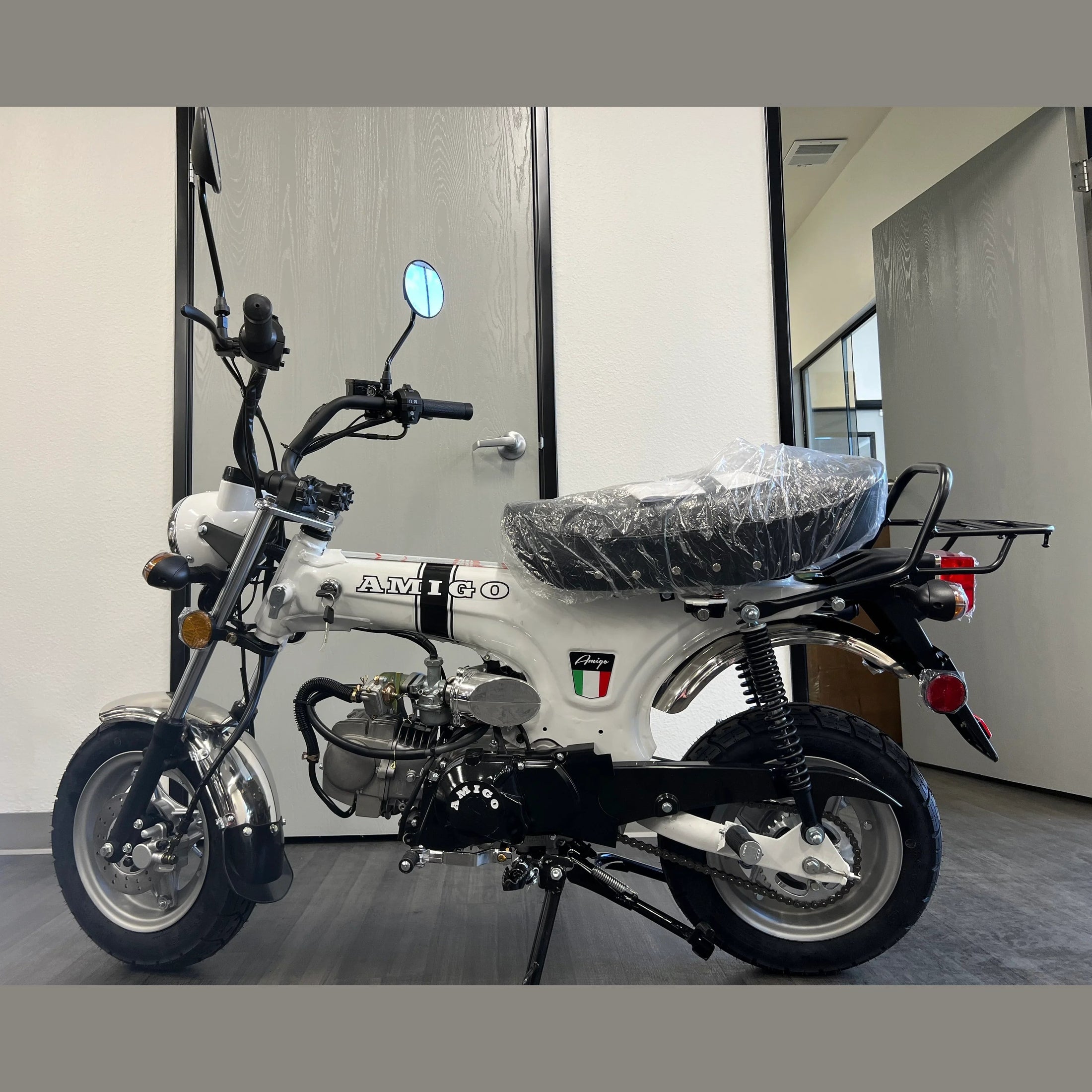 White Amigo Rocky 125cc mini motorcycle with black stripes and silver-spoked wheels