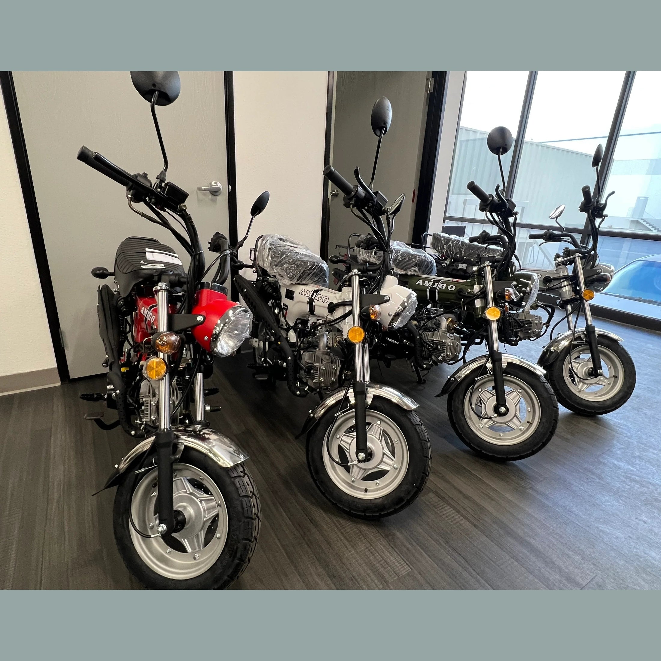 Four color options of Amigo Rocky 125cc mini motorcycles displayed in a row