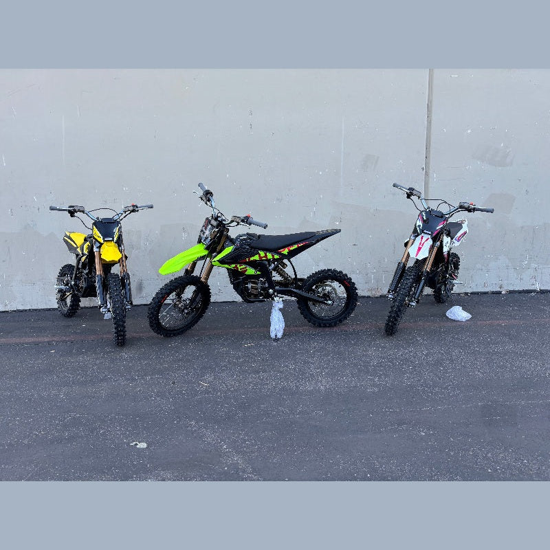 Yellow green and red Surron Hyper Bee electric dirt bikes grouped