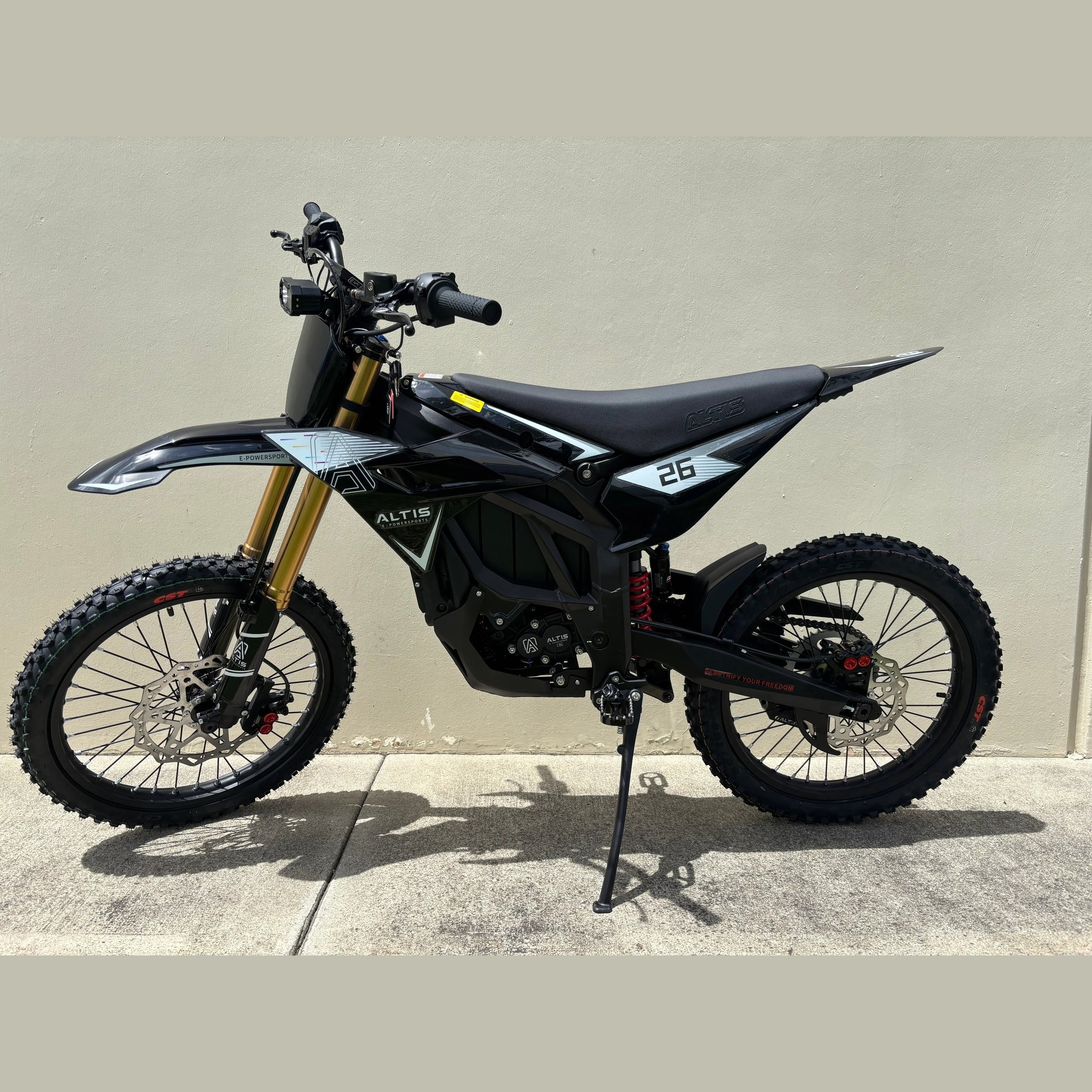 side profile of black Atlis Sigma off-road electric dirt bike with gold forks
