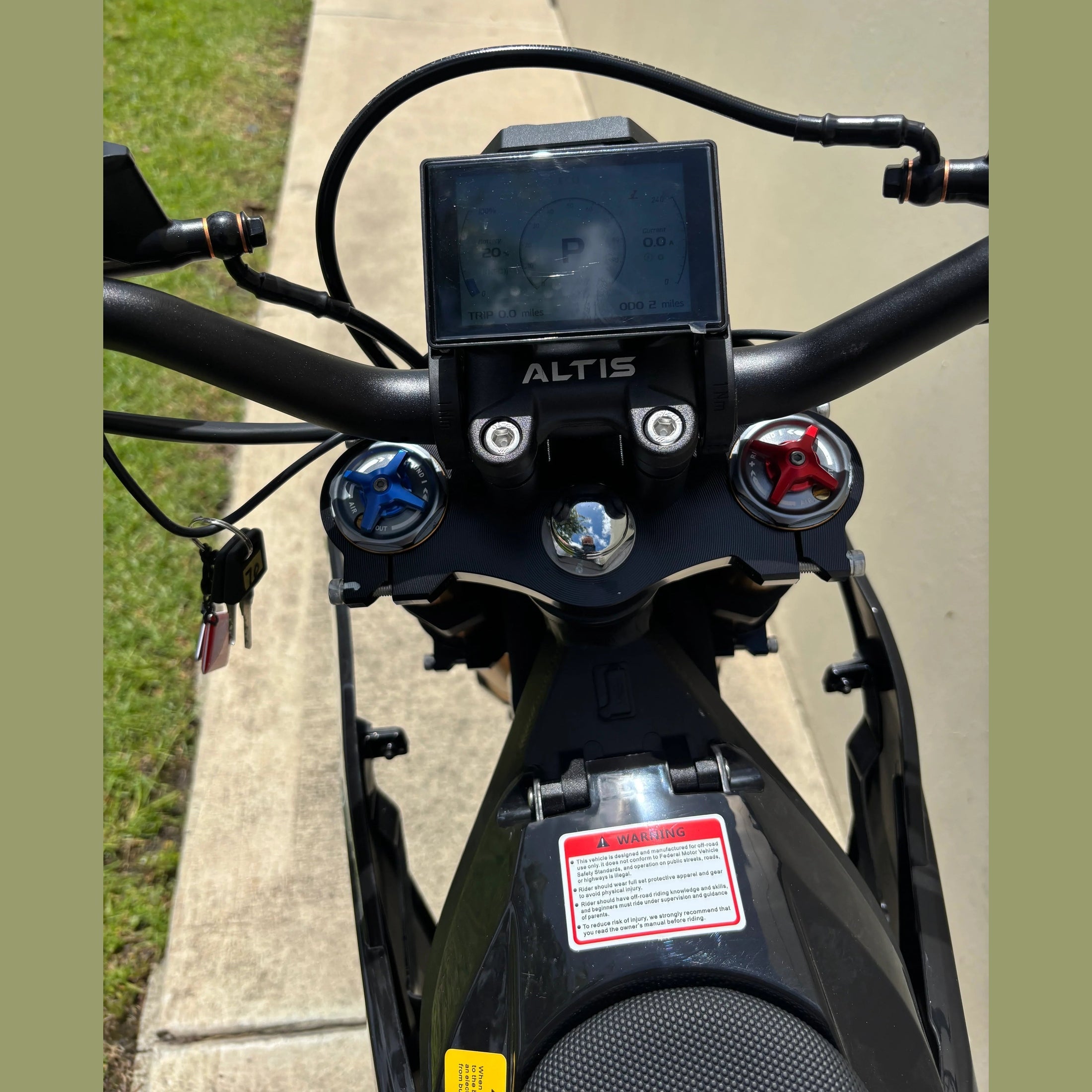 digital display and gauge cluster on black Atlis Sigma electric dirt bike handlebars