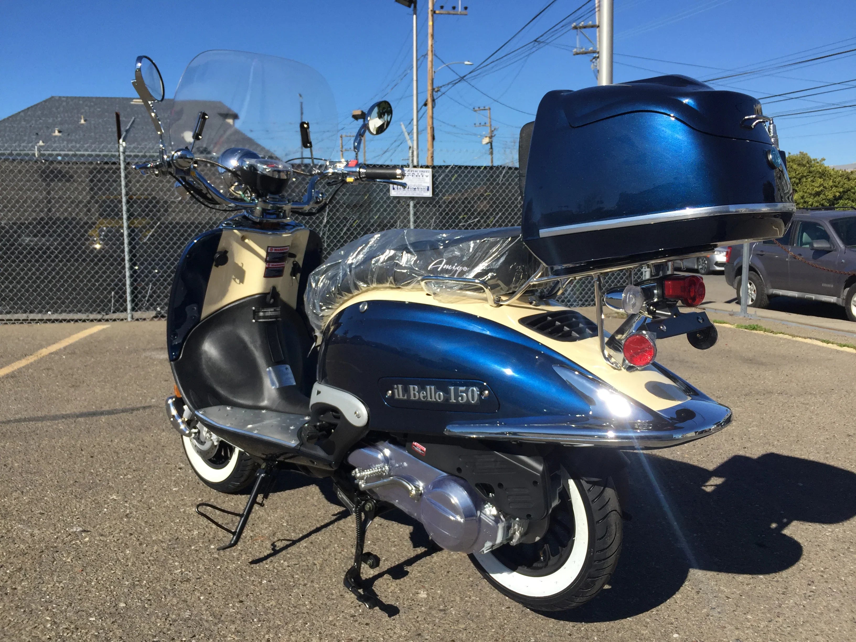 Blue and cream Il Bello 150cc scooter with rear storage parked outdoors in sunlight