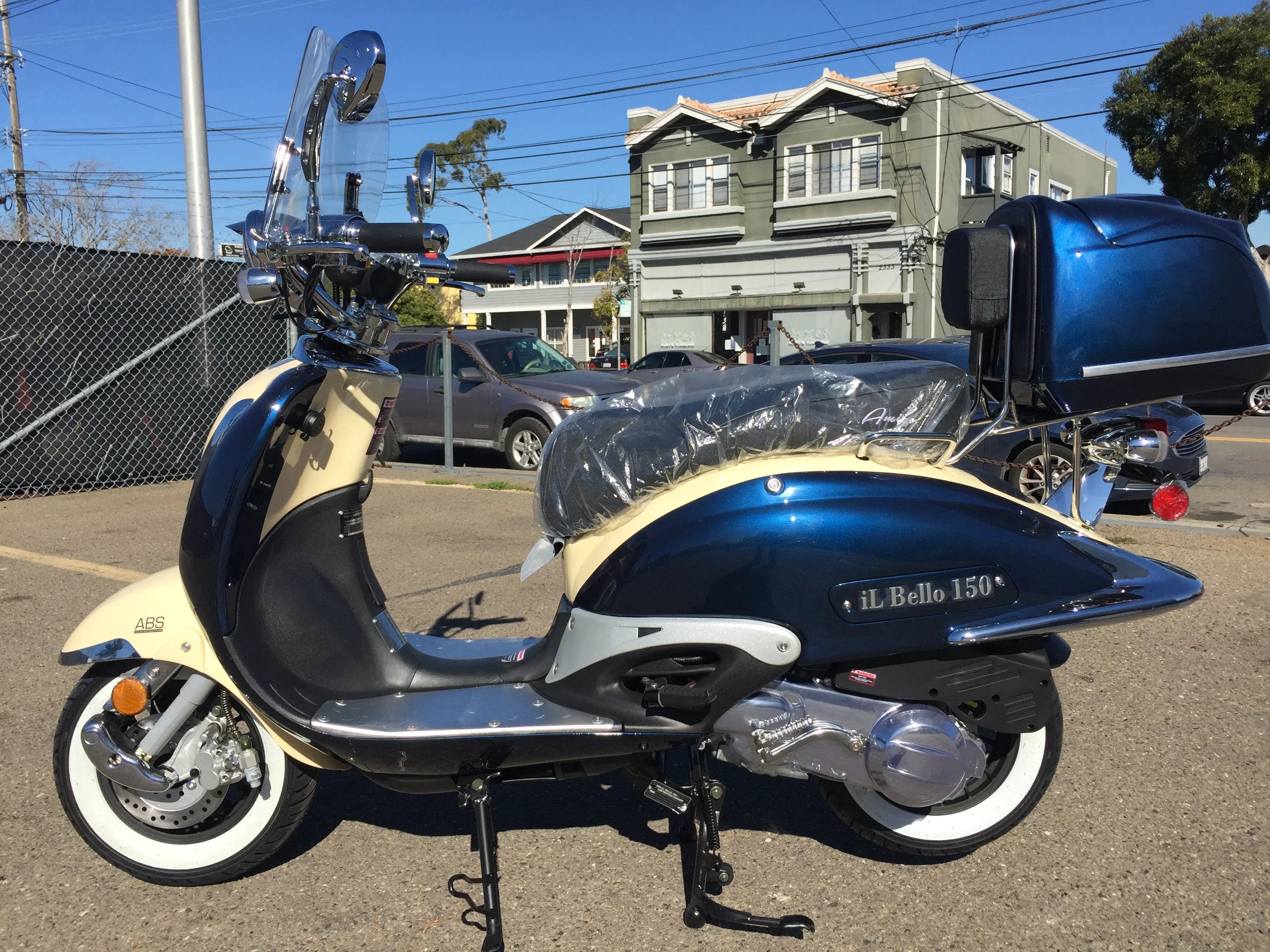 Blue and cream iL Bello 150cc scooter with ABS brakes parked outdoors