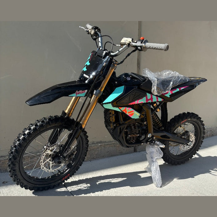 Black Surron Hyper Bee electric dirt bike turquoise pink decals
