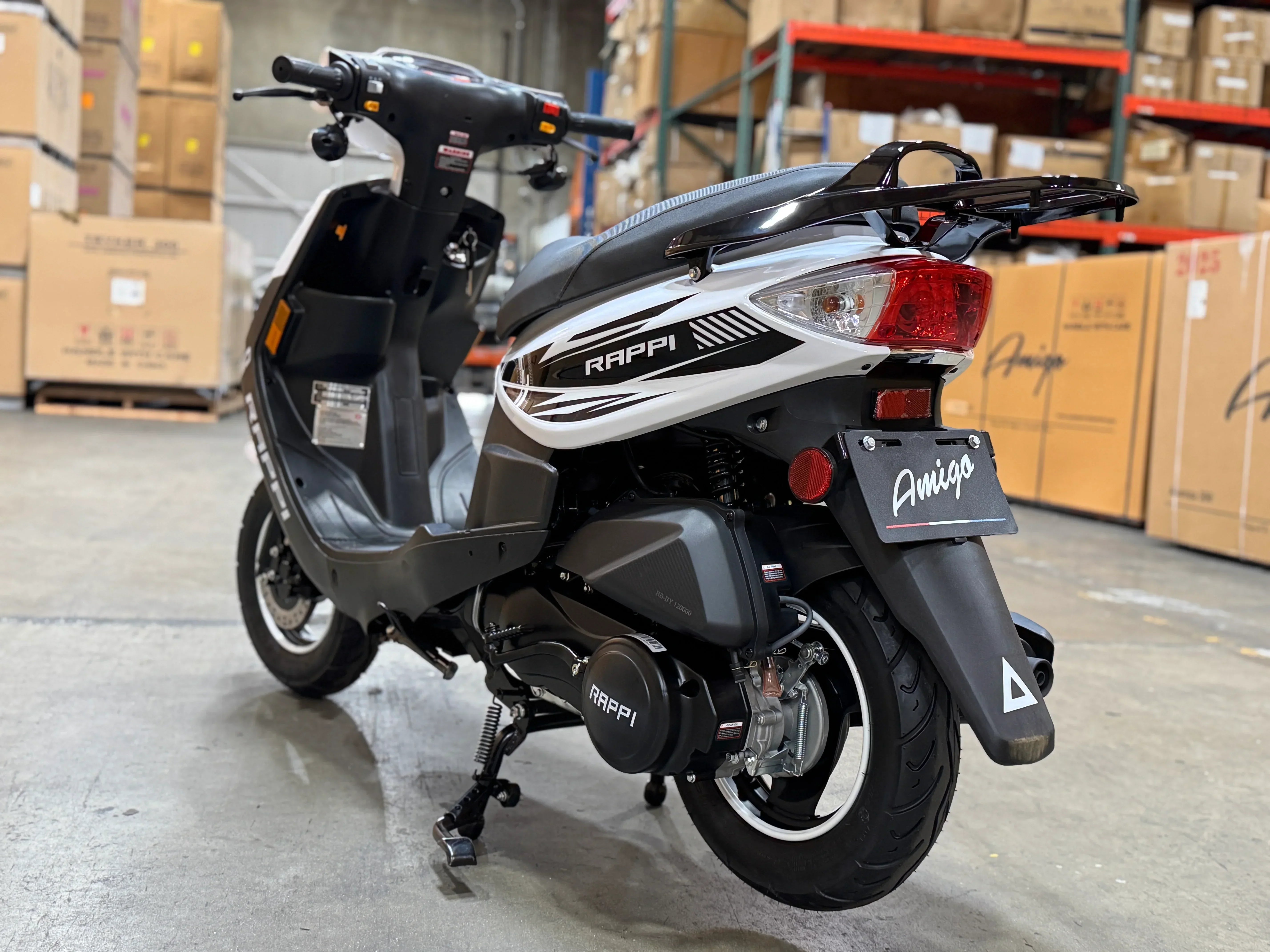Rappi Amigo scooter in warehouse, black and white design with rear rack and taillight
