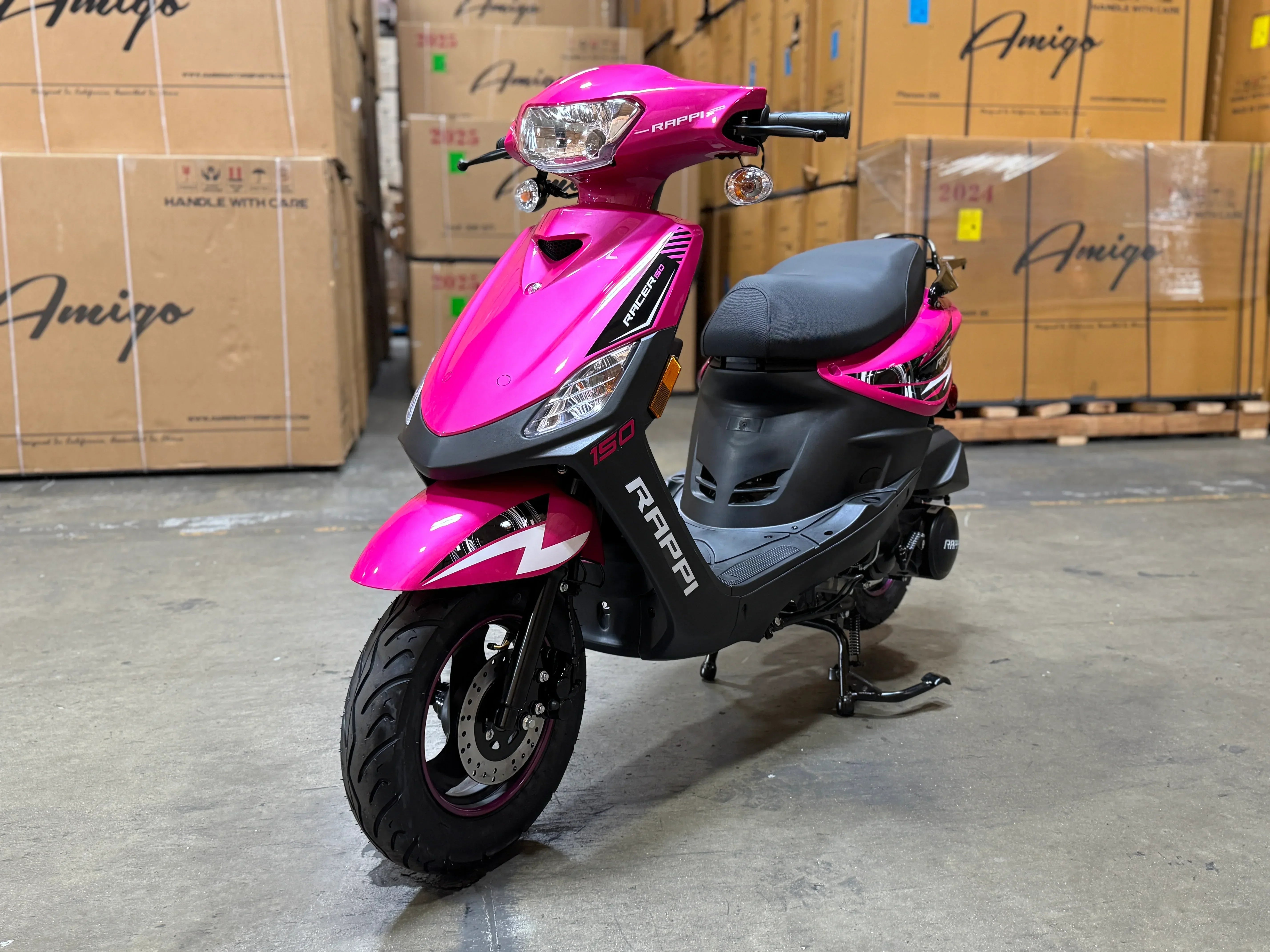 Pink RAPPI 150cc scooter with black accents, parked in a warehouse with Amigo boxes.